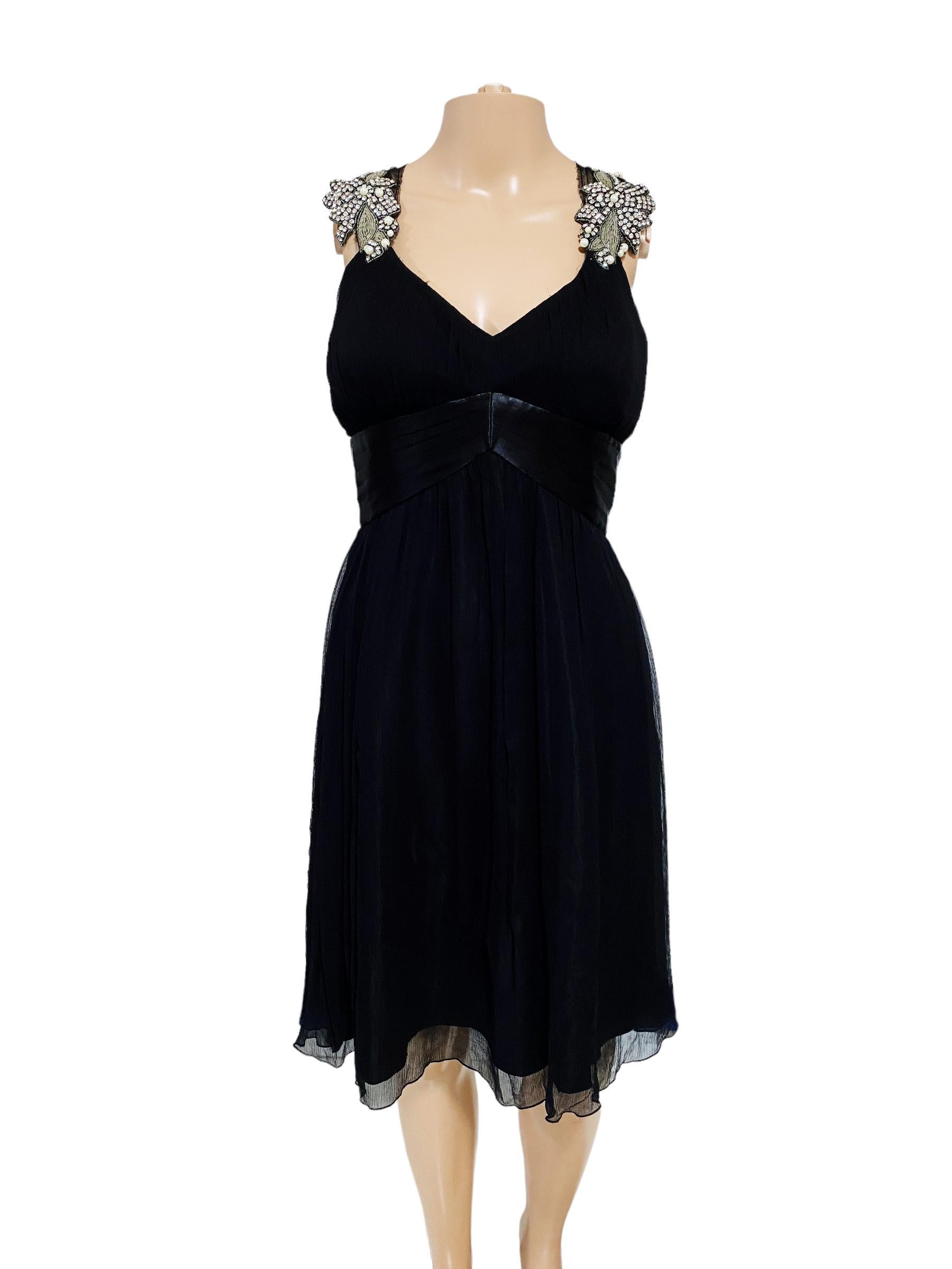 Vintage Blumarine sleeveless dress in black cotton blend with gorgeous crystals and metallic rhinestones detailing embellishments on the shoulders and back with a tulle/silk cloth. Rare and hard to find these days.

Very Iconic and very BLUMARINE.