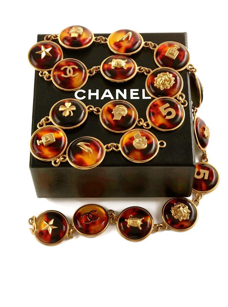 Measurements:
Height: 1 1/8 inches (2.85 cm)
Length: 29 4/8 inches (74.93 cm)

Could be use as a belt or a necklace.

Features:
- 100% Authentic CHANEL.
- Iconic Chanel logo lucky charms on lucite tortoise shell.
- Charms are: Star, CC Logo, Turtle,