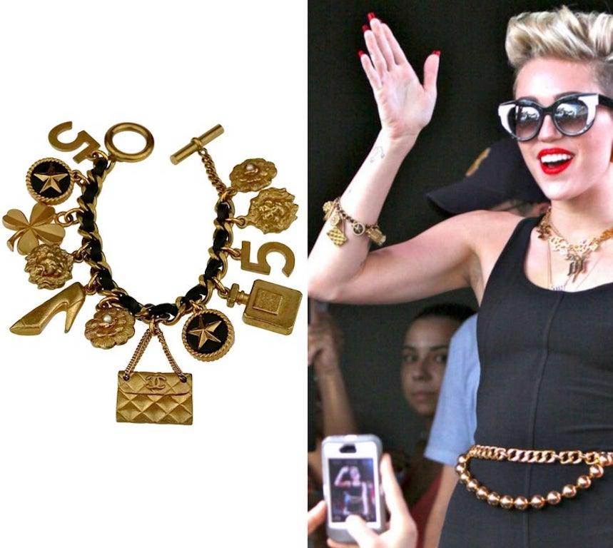 Vintage Iconic CHANEL Lucky Charm Leather Chain Bracelet

Measurements:
Height: 1.77 inches (4.5 cm as the largest)
Wearable Length: 7.48 inches (19 cm)

As seen on Miley Cyrus.

Features:
- 100% Authentic CHANEL.
- Chunky chain entwined with black