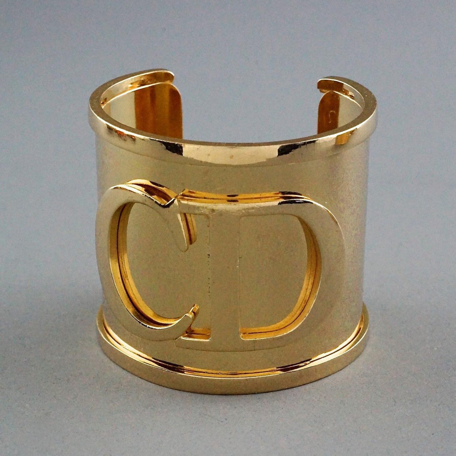 Vintage Iconic CHRISTIAN DIOR CD Logo Initials Wide Cuff Bracelet

Measurements:
Height: 2.20 inches (5.6 cm)
Total Circumference: 6.81 inches (17.3 cm) including the opening
Opening: 1.37 inches (3.5 cm)

Features:
- 100% Authentic CHRISTIAN