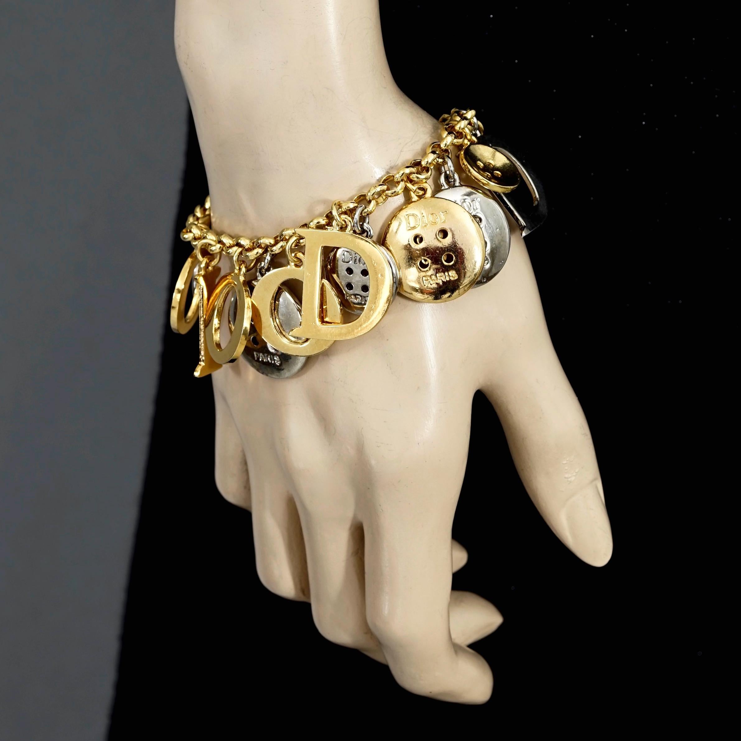 Vintage Iconic CHRISTIAN DIOR Letters and Buttons Charm Bracelet

Measurements:
Height: 1.18 inches (3 cm)
Wearable Length: 7.87 inches (20 cm)

Features:
- 100% Authentic CHRISTIAN DIOR.
- Iconic DIOR letter and button charm bracelet.
- Toggle