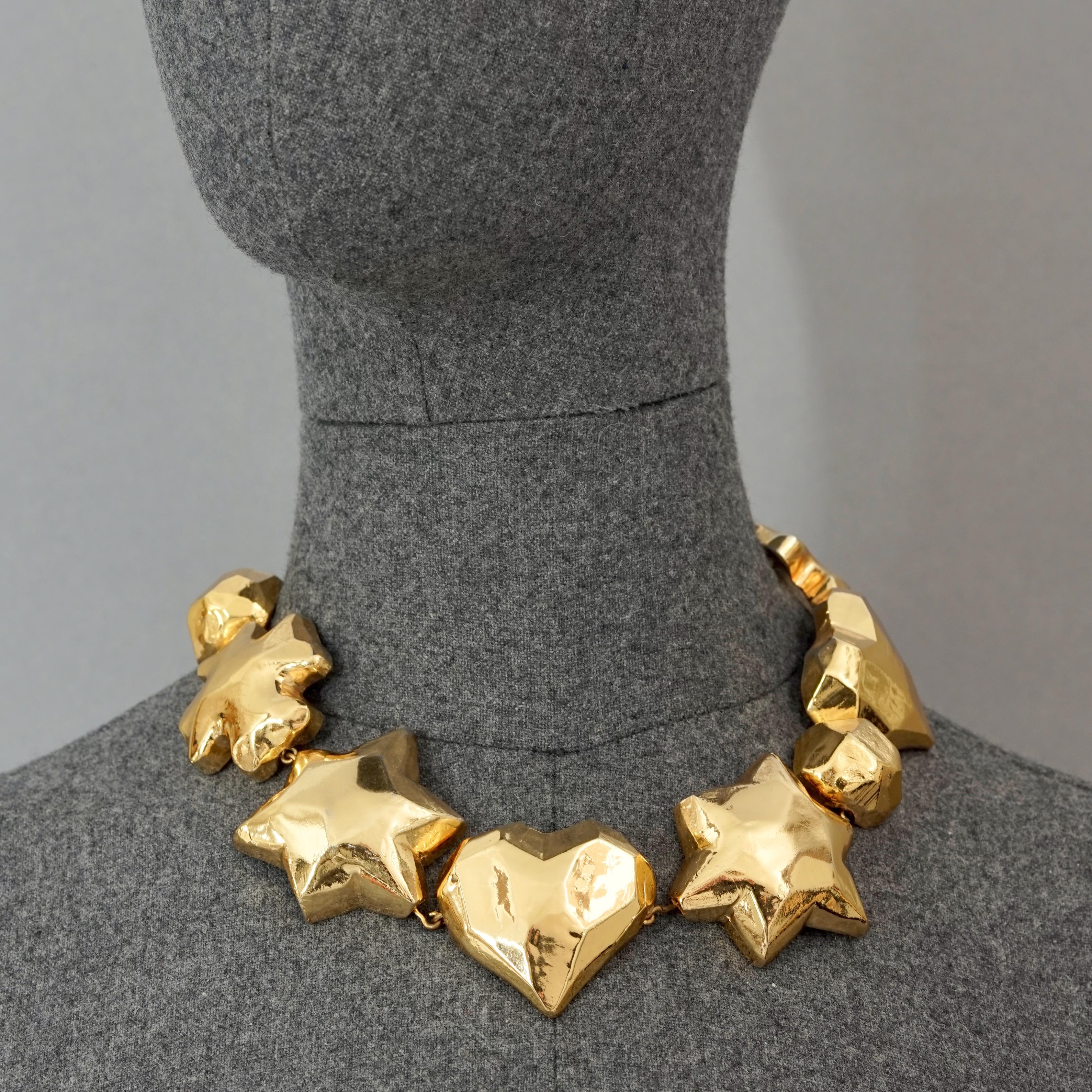 Vintage Iconic CHRISTIAN LACROIX Cross Star Heart Choker Necklace

Measurements:
Height: 1.73 inches (4.4 cm)
Wearable Length: 16.14 inches to 18.11 cm (41 cm to 46 cm) adjustable

Features:
- 100% Authentic CHRISTIAN LACROIX.
- Chunky 3D iconic