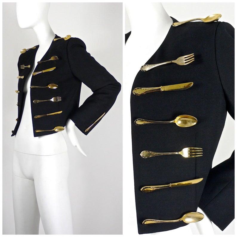 Vintage Iconic MOSCHINO Couture Dinner Jacket

Measurements taken laid flat, please double bust and waist:
Shoulder: 16 inches
Sleeves: 24 inches
Bust: 19 inches
Length: 19 inches 

A very RARE Moschino Dinner Jacket.
From his 