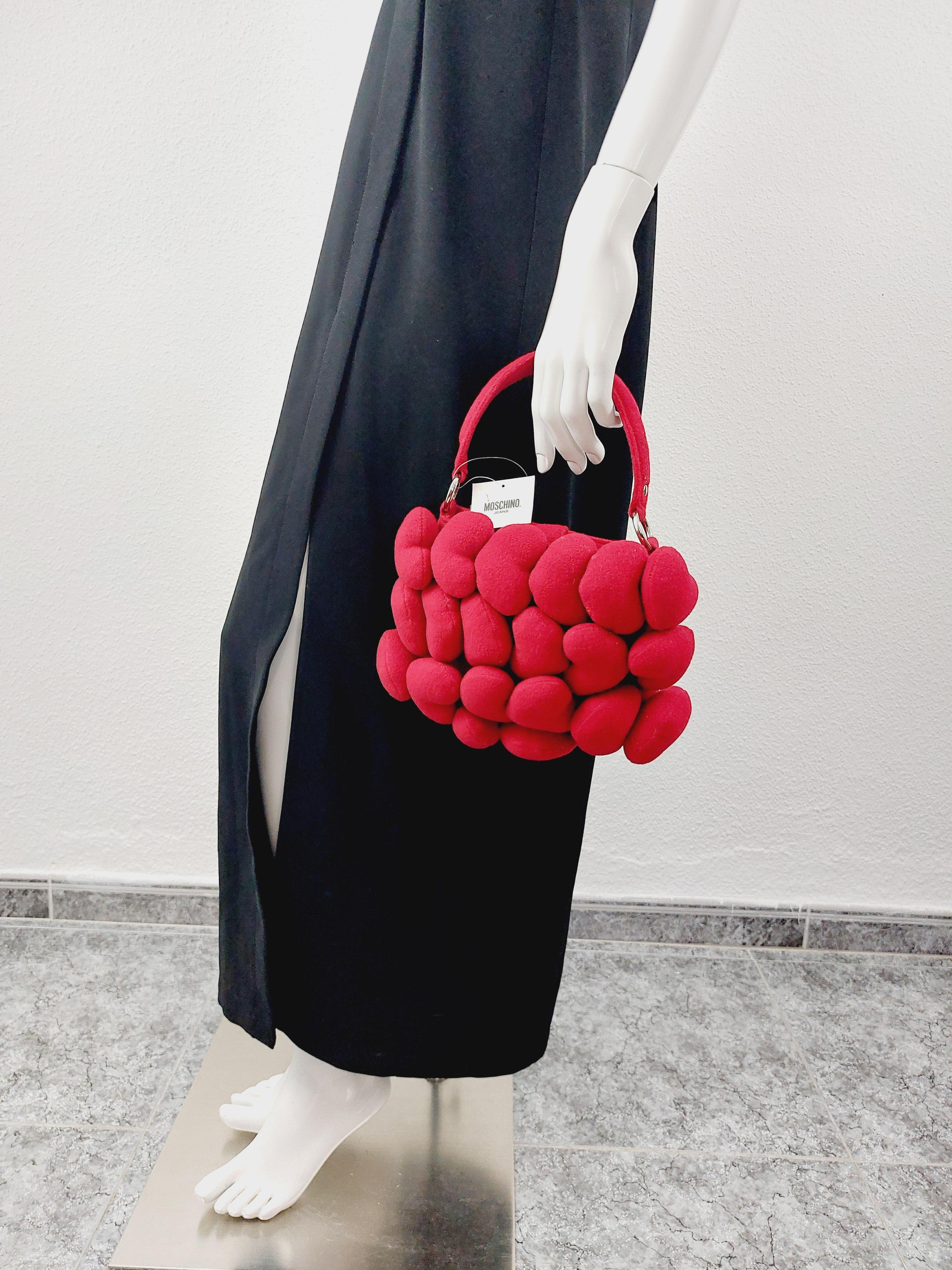Vintage Iconic Moschino Heart Red Plush Love Toy Whimsical HandBag Gluch
Iconic MOSCHINO Heart bag. 
This handbag features: - Red wool and viscose material. 
- 20 puffy hearts at front.
 - Magnetic snap closure. 
- Top handle. 
- Silver toned