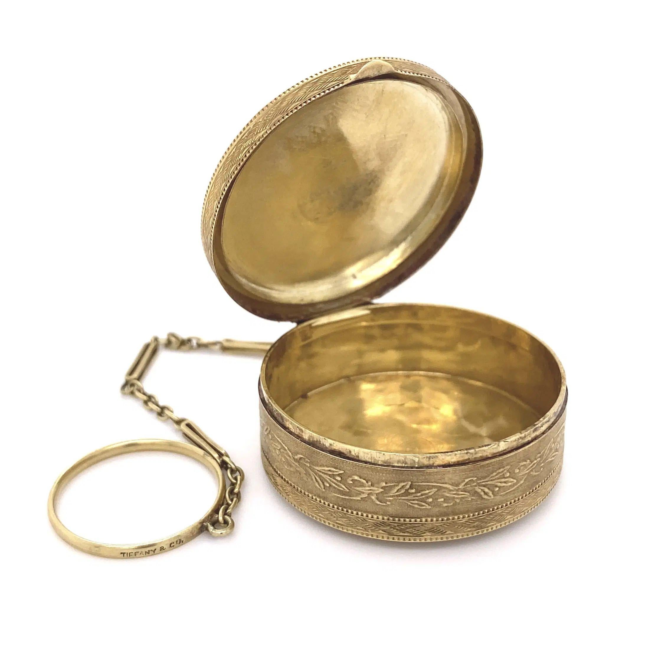Simply Beautiful! Vintage Iconic TIFFANY & CO. 14K Yellow Gold Round Box with Ring Holder. Beautifully Hand engraved designs and detailing decorating the Top, Bottom and Sides. Center with initialed monogram: MRM. Approx. dimensions: 1.50” x 1.50” w