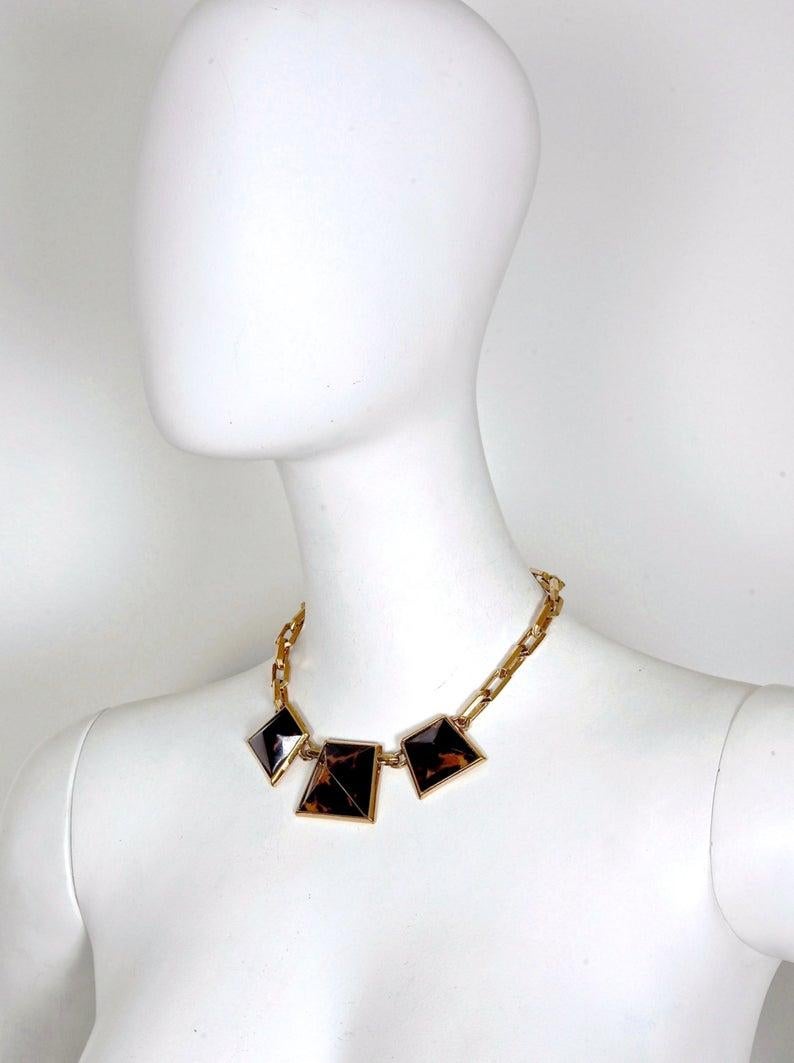 Vintage Iconic YSL Yves Saint Laurent Leopard Pyramid Necklace

Measurements:
Height: 1 3/8 inches (3.49 cm)
Width: 1 4/8 inches (3.81 cm)
Depth: 7/8 inch (2.22 cm)

Features:
- 100% Authentic YVES SAINT LAURENT.
- Raised pyramid with iconic leopard