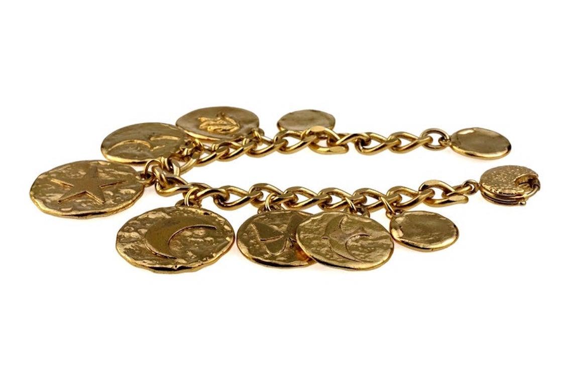 Vintage Iconic YVES SAINT LAURENT Ysl Emblem Medallion Charm Bracelet

Measurements:
Height: 1.65 inches (4.2 cm)
Wearable Length: 8.46 inches (21.5 cm) maximum

Features:
- 100% Authentic YVES SAINT LAURENT.
- Chunky discs with iconic heart, star,