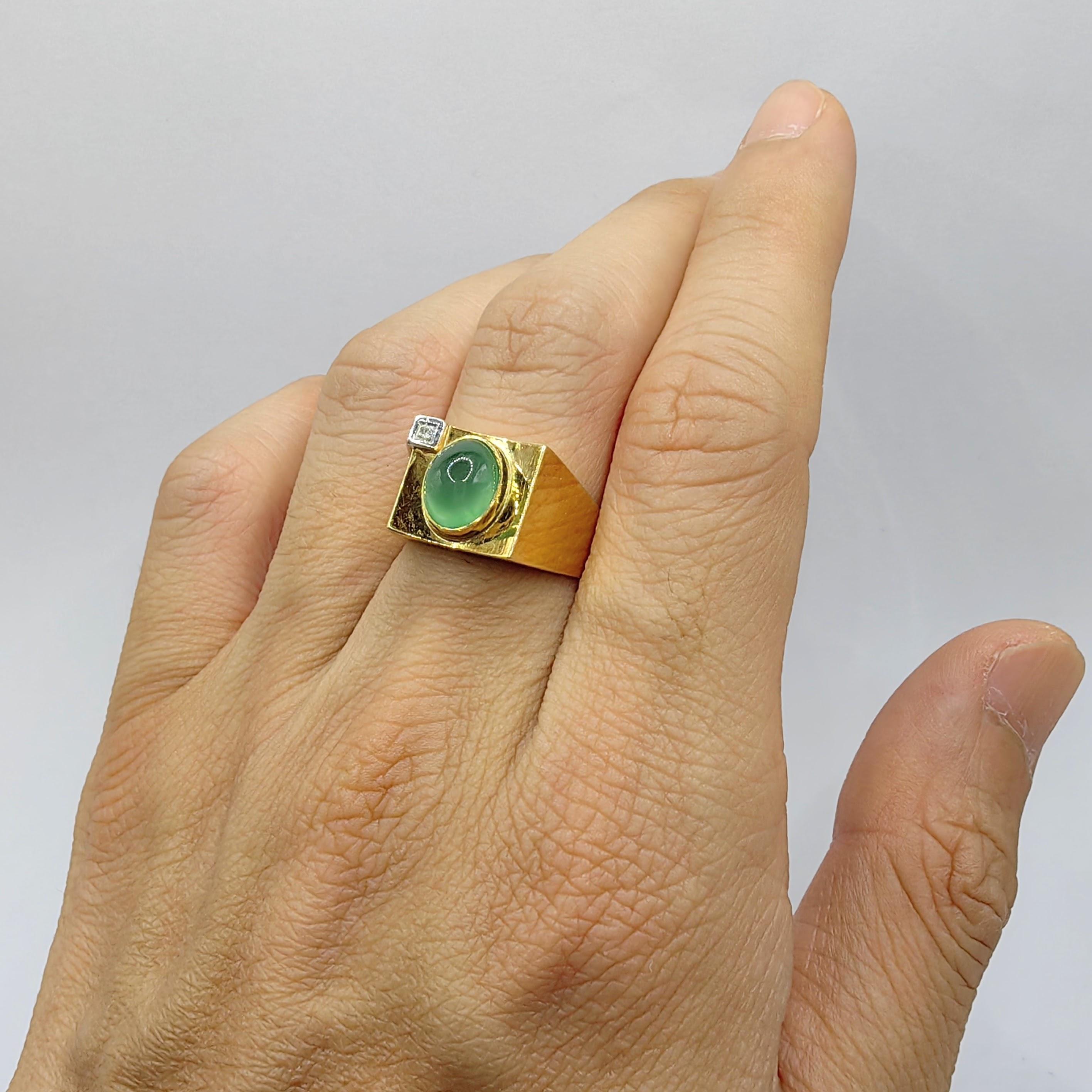 Introducing our Vintage Icy Light Apple Green Jadeite Jade Diamond Ring in 14K Two-tone Gold, a captivating piece that exudes elegance and showcases the natural beauty of jadeite jade. This exquisite ring features an icy light apple green cabochon
