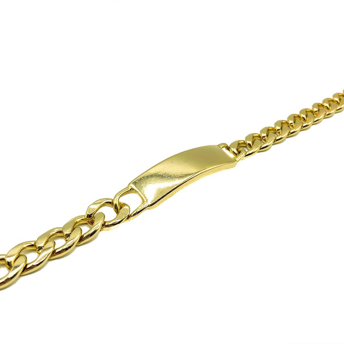 A Vintage ID Bar Necklace. Crafted in weighty lustrous gold plated metal. Featuring an ID style bar suspended between chunky chain. In very good vintage condition without damage or repair, approx. adjustable 43-50cms. An uber cool style statement