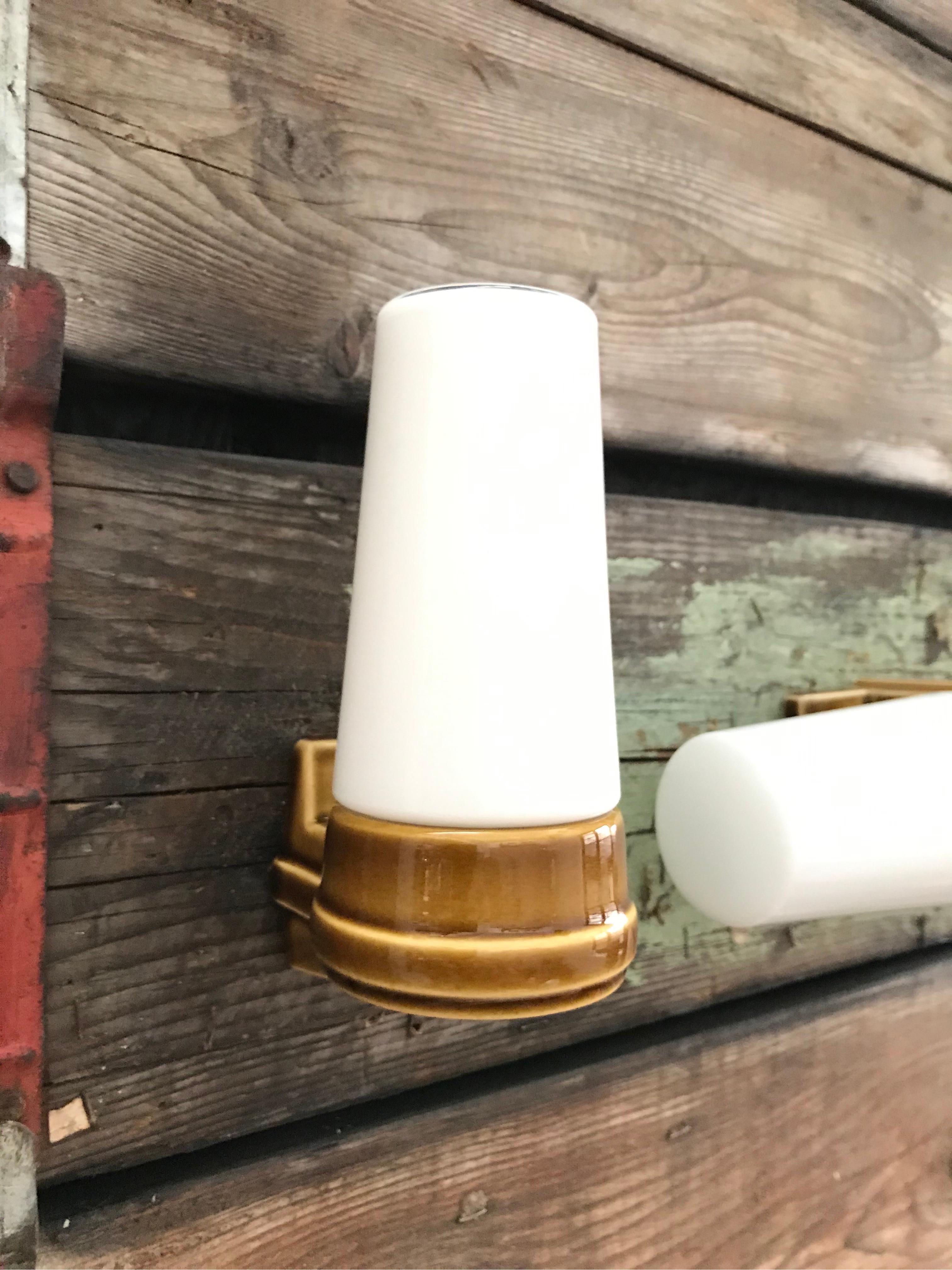 A set 3 vintage Ifö of Sweden ceramic bathroom lamps model 6035 and 6060 from the 1960s in tan.
Designed by Sigvard Bernadotte. 
Opaline glass shades. 
Ceramic bulb holders for an E15 bulb
Lamps can be used as up or down lights.
A set of 3 is