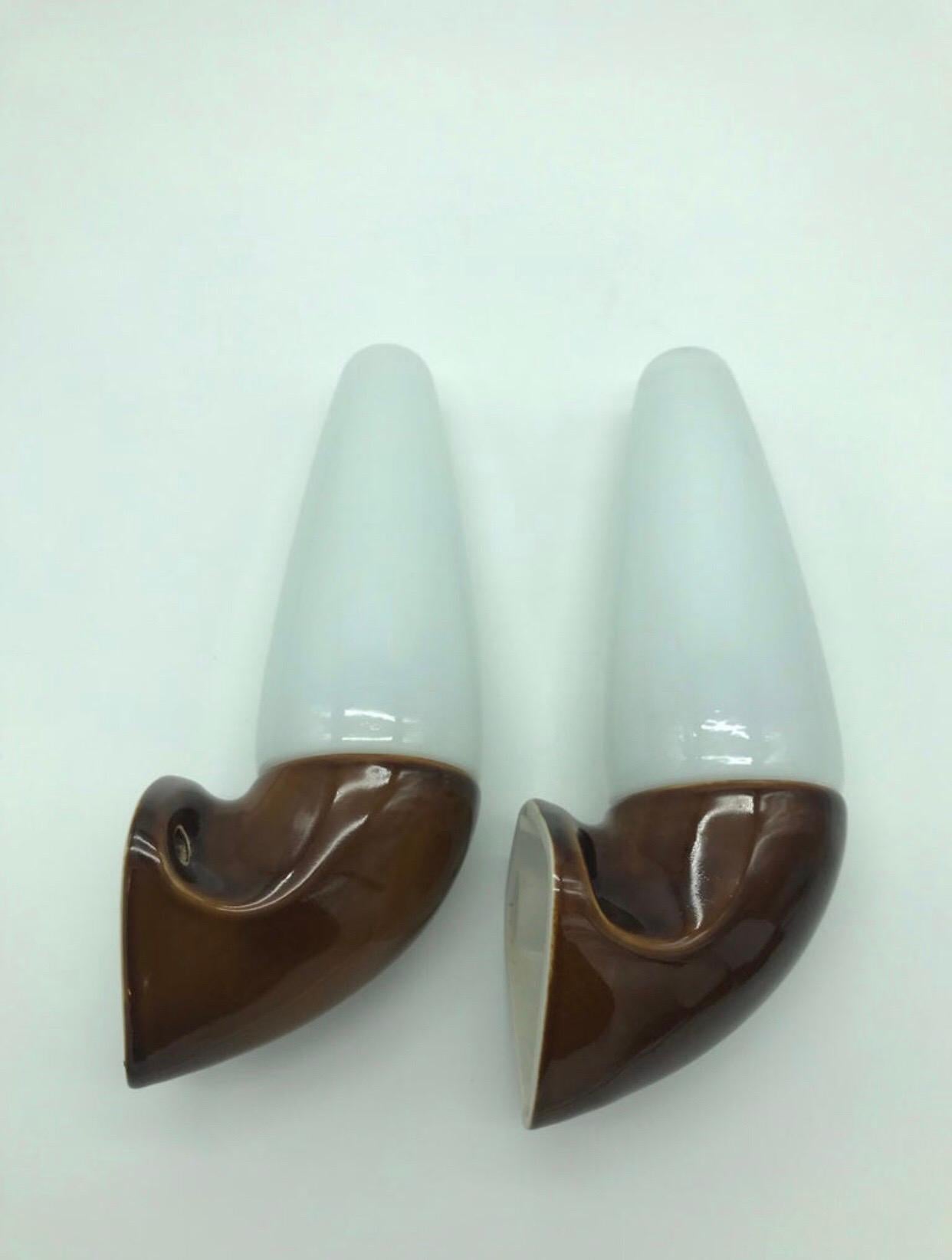 A pair of vintage Ifö of Sweden ceramic bathroom lamps from the 1960s in retro brown
Designed by Sigvard Bernadotte. 
Opaline glass shades. 
Ceramic bulb holders for an E14 bulb
Lamps can be used as up or down lights.
In great condition and
