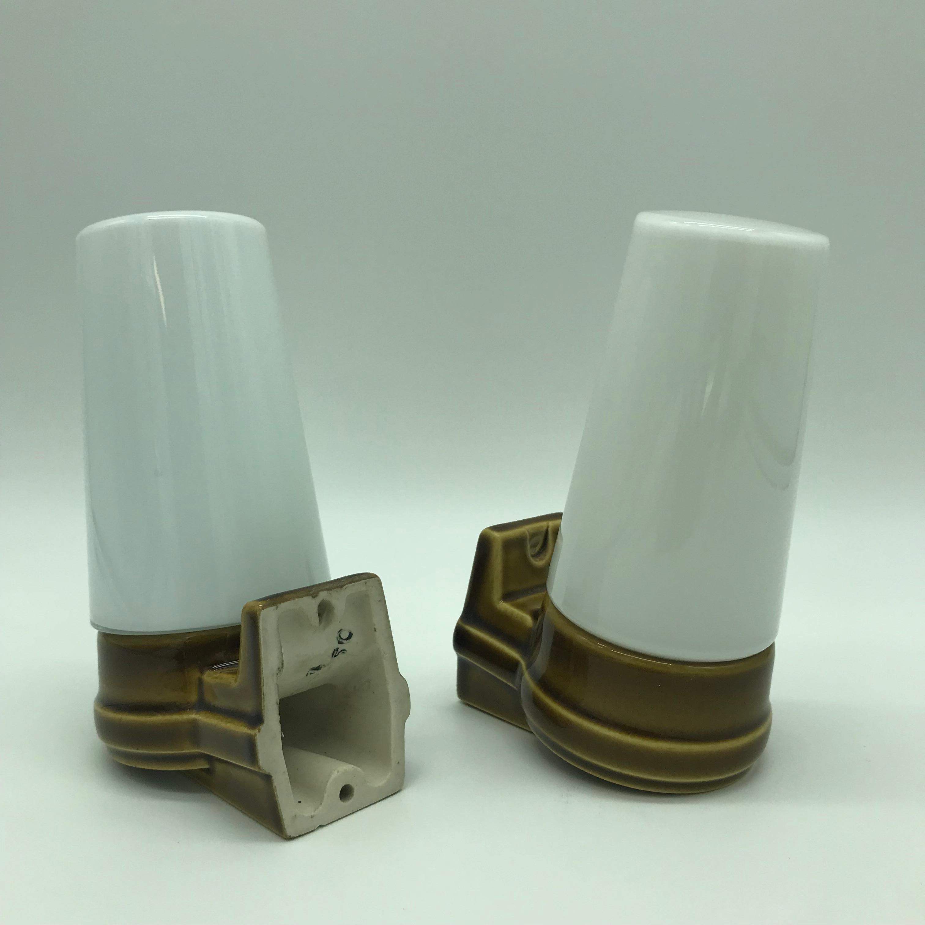 A pair of vintage Ifö of Sweden ceramic bathroom lamps from the 1960s 
Opaline glass shades 
Ceramic bulb holders for an E15 bulb 
In great condition and ready to use.
Designed by Sigvard Oscar Fredrik Bernadotte, Prince Bernadotte, Count of