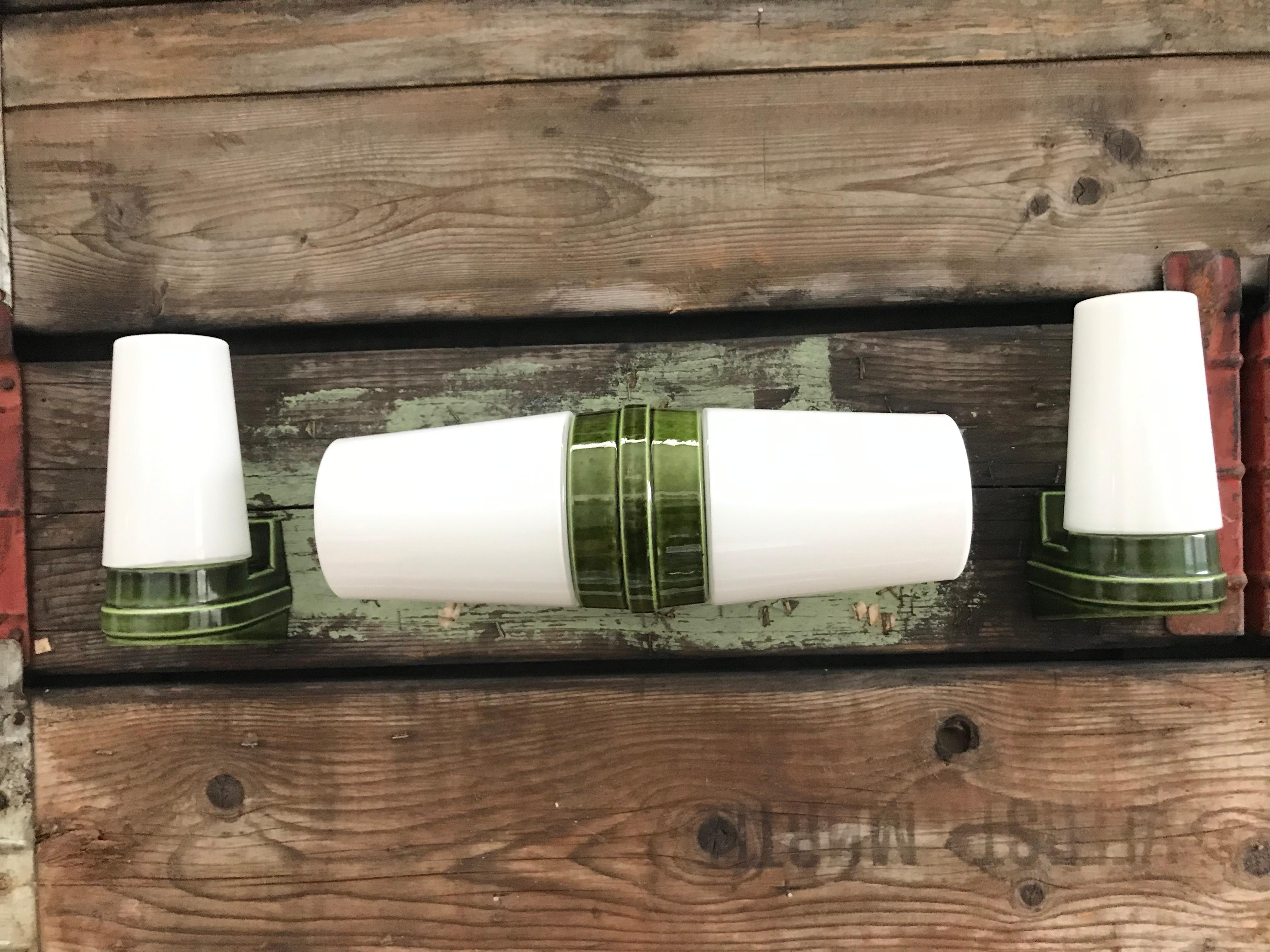 A set 3 vintage Ifö of Sweden ceramic bathroom lamps model 6065 and 6080 from the 1960s in lime green.
Designed by Sigvard Bernadotte. 
Opaline glass shades. 
Ceramic bulb holders for an E15 bulb
Lamps can be used as up or down lights.
In great