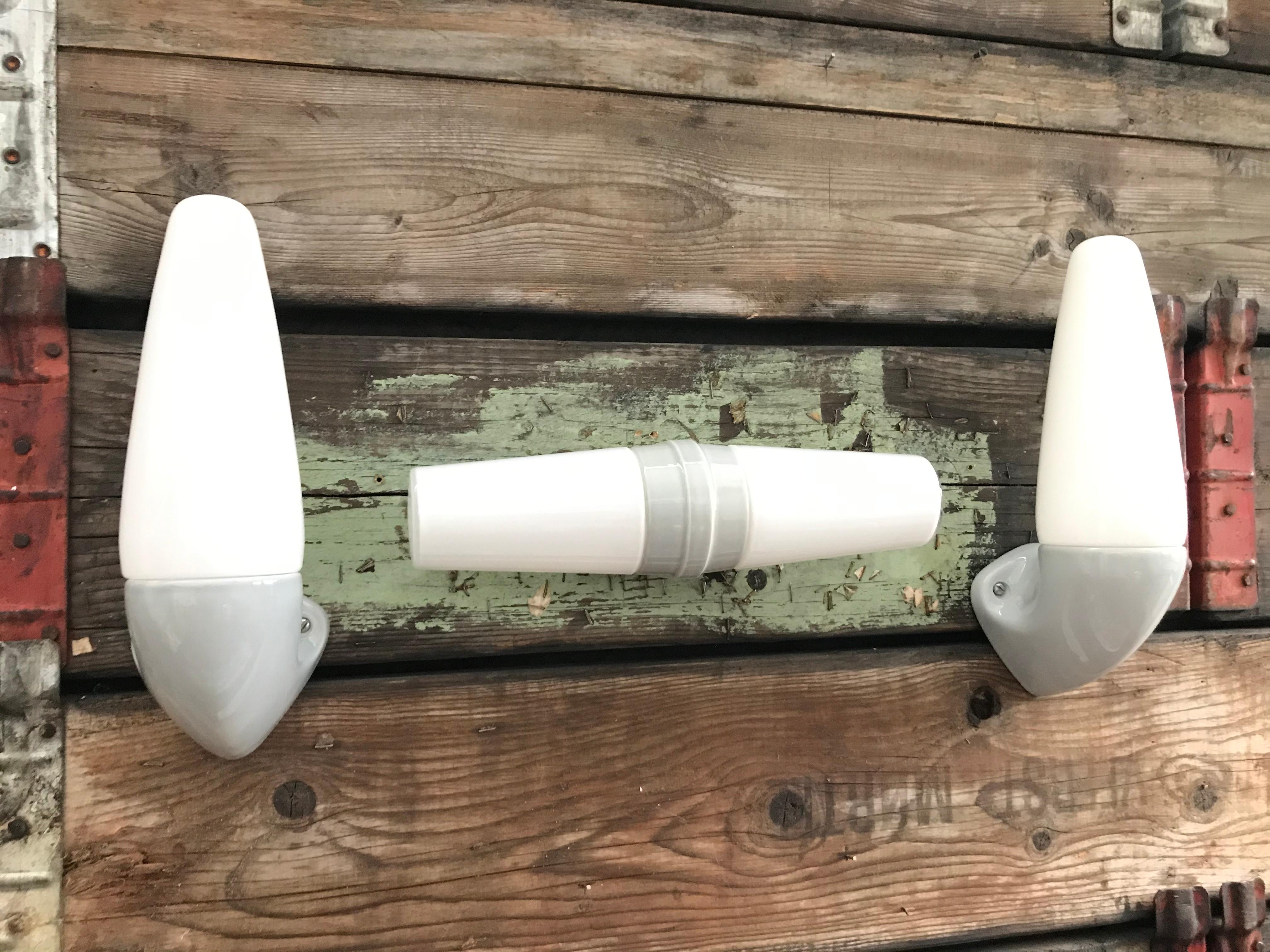 A set 3 vintage Ifö of Sweden ceramic bathroom lamps model 6035 and 6060 from the 1960s in grey.
Designed by Sigvard Bernadotte. 
Opaline glass shades. 
Ceramic bulb holders for an E15 bulb
Lamps can be used as up or down lights.
A set of 3 is