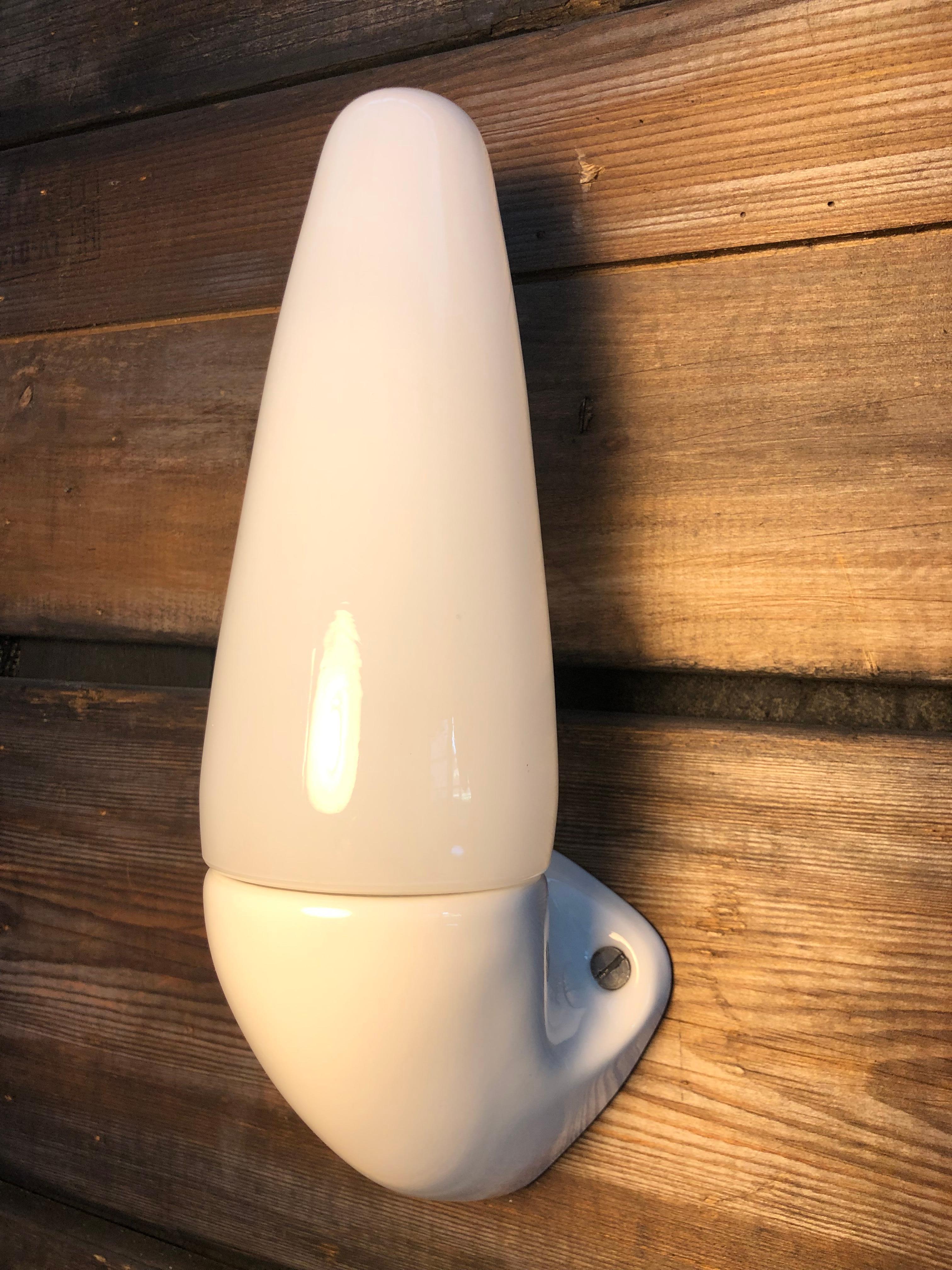 Vintage Ifö of Sweden ceramic bathroom lamps from the 1960s in white.. 
Designed by Sigvard Bernadotte. 
Opaline glass shades. 
Ceramic bulb holders for an E14 bulb
Lamps can be used as up or down lights.
In great condition and ready to use.
Will be