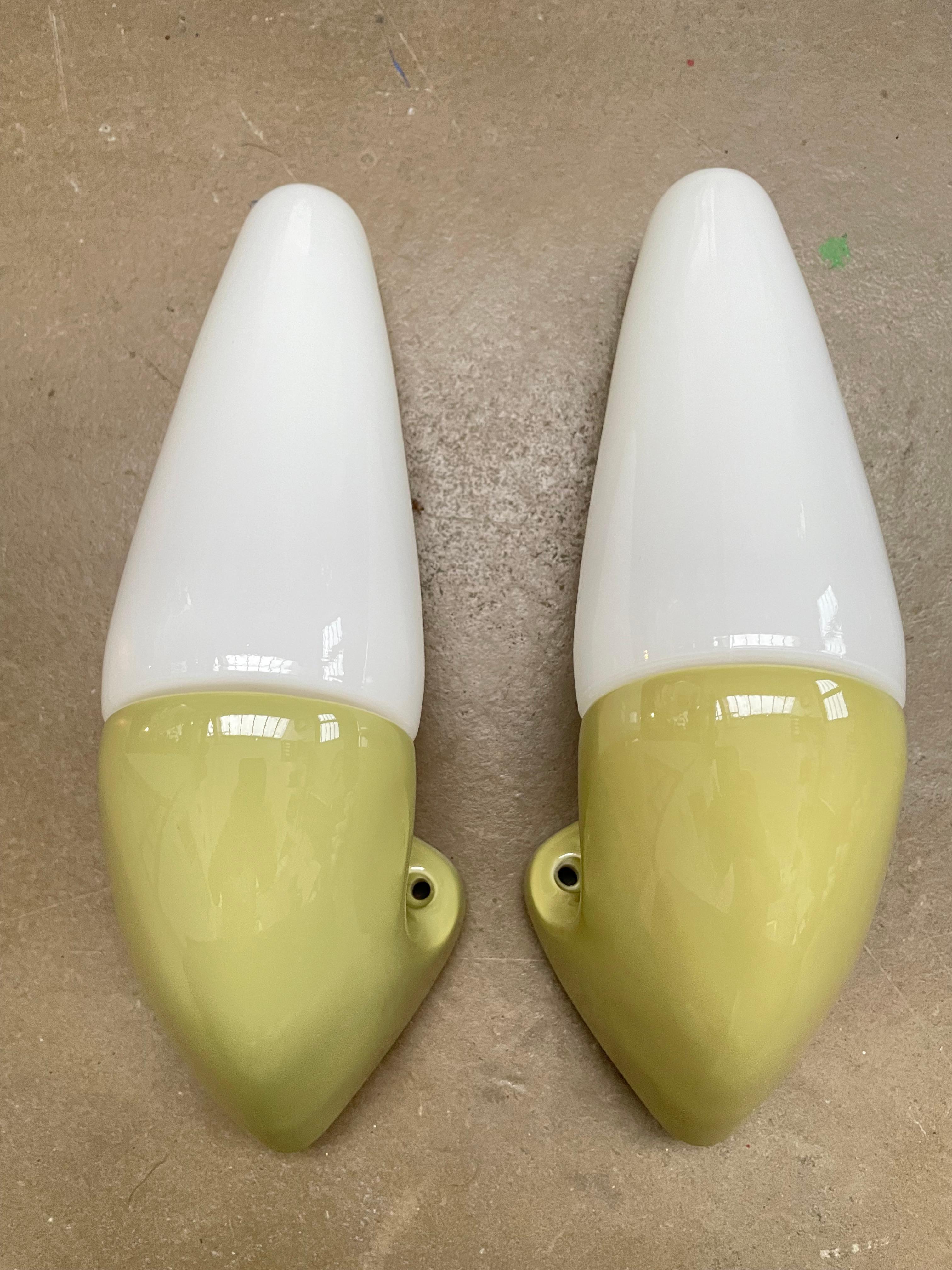 Vintage Ifö of Sweden ceramic bathroom lamps from the 1960s in a lime green color. 
Designed by Sigvard Bernadotte. 
Opaline glass shades. 
Ceramic bulb holders for an E14 bulb
Lamps can be used as up or down lights.
In great condition and ready to