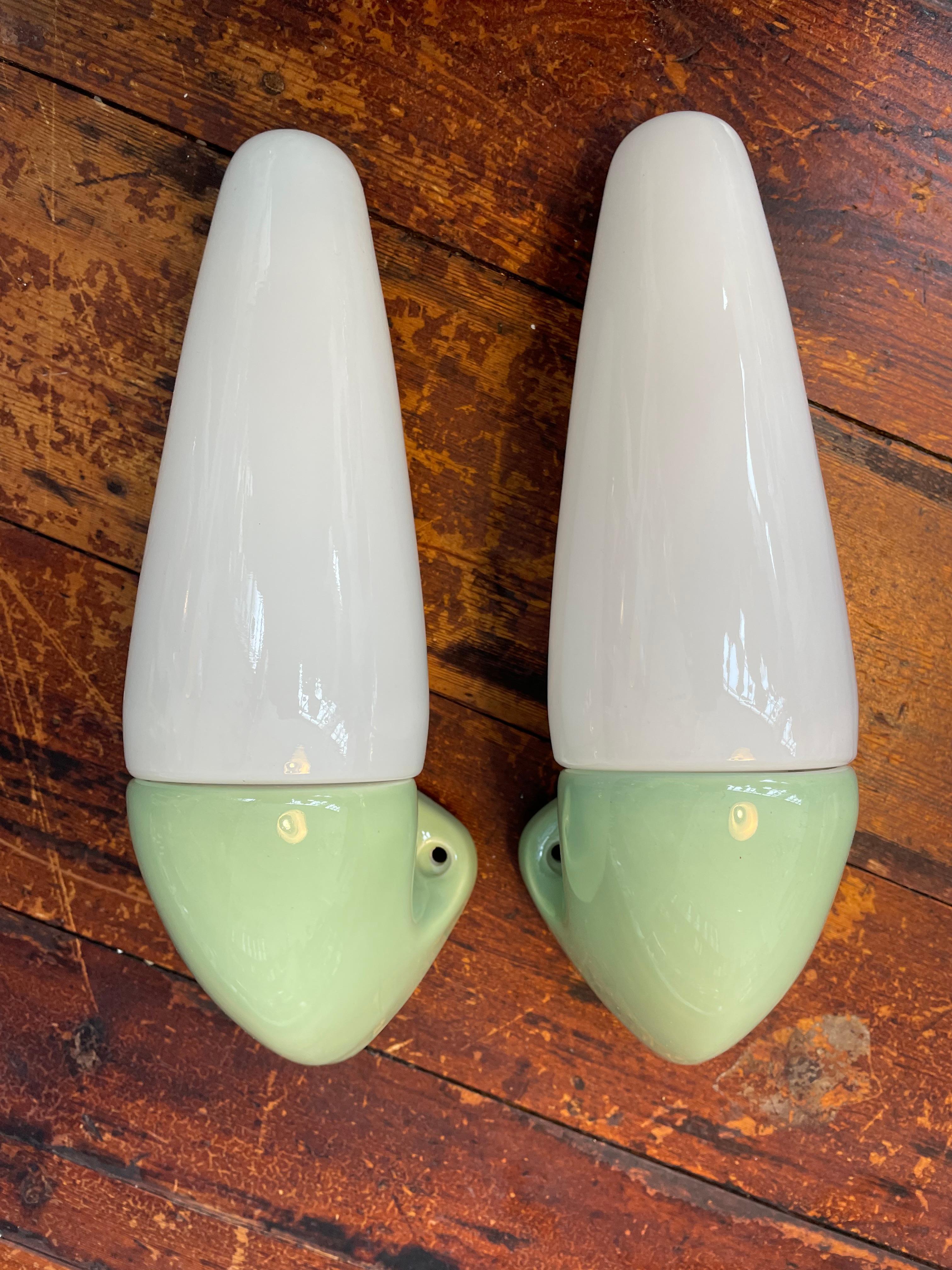 Vintage Ifö of Sweden ceramic bathroom lamps from the 1960s in mint green.
Model 6035. 
Designed by Sigvard Bernadotte. 
Opaline glass shades. 
Ceramic bulb holders for an E14 bulb
Lamps can be used as up or down lights.
In great condition and ready