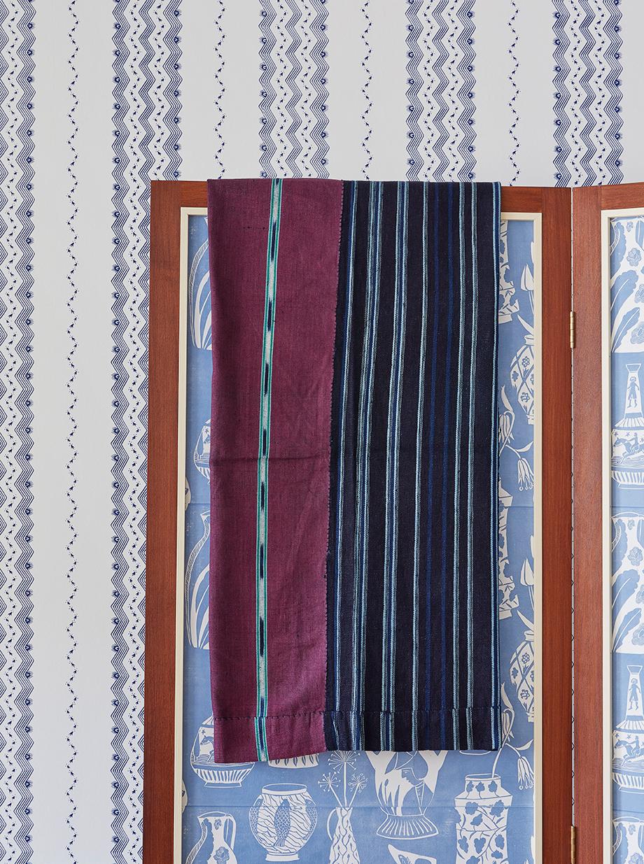 Nigeria, 1950's

Ikat patterned Woman’s weave wrapper cloth from one of the Eastern Yoruba sub-groups or perhaps the Igarra. A handsome combination of indigo dyed handspun cotton and wine red industrial thread with narrow ikat warp stripes framed
