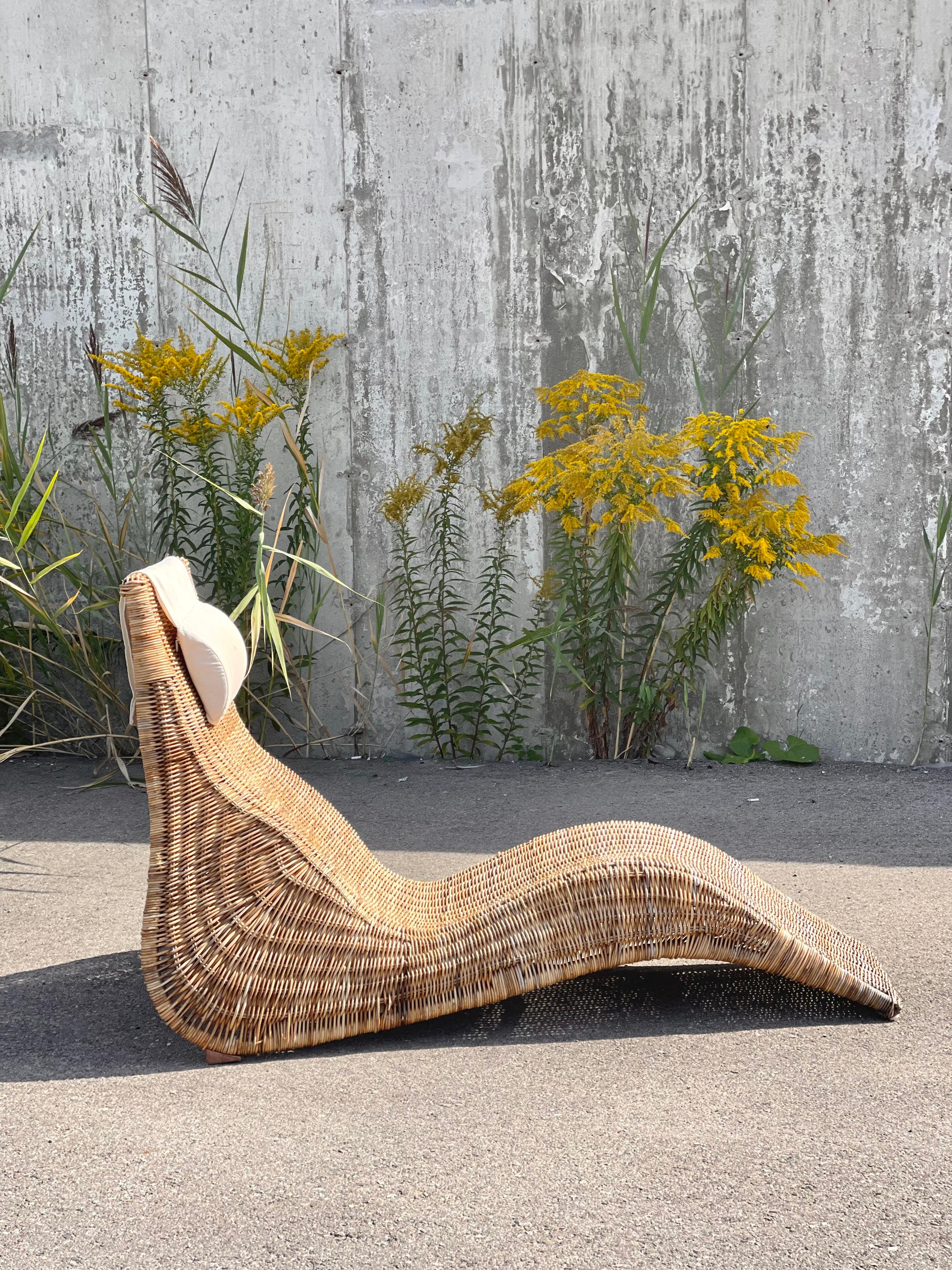 cult classic Ikea “Karlskorna” rattan lounger with original weighted canvas headrest cushion. 

designed by Swedish born industrial designer Karl Malmvall. 

a treat to perch in, and a sight to behold! beautifully woven rattan with a mildly aquatic