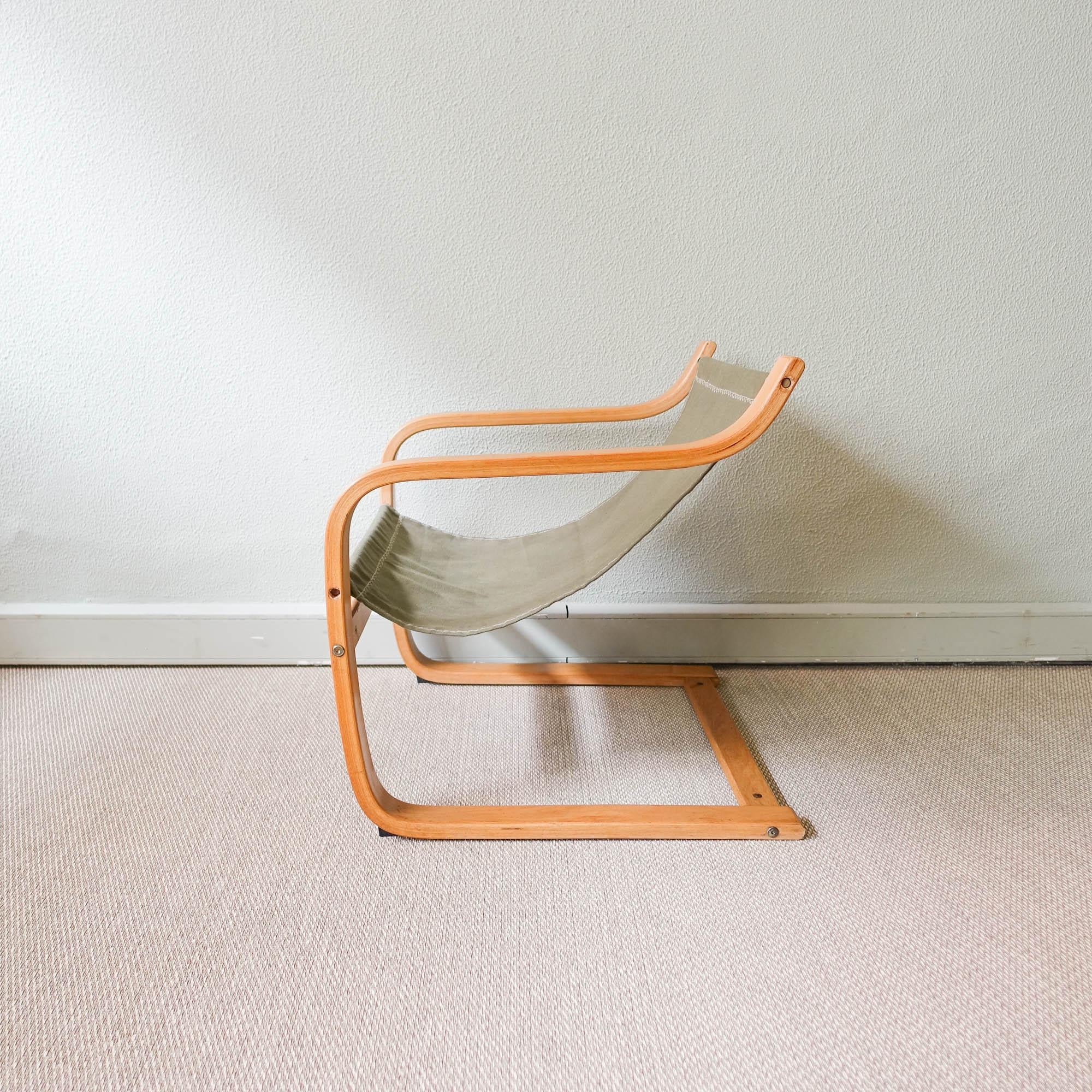 This lounge chair was designed and produced by IKEA, in Sweden, during the 1970's. It is made of bent beech wood and the seat is in green cotton canvas. It is a comfortable piece, with a design in the style of Alvar Aalto designs. In original and