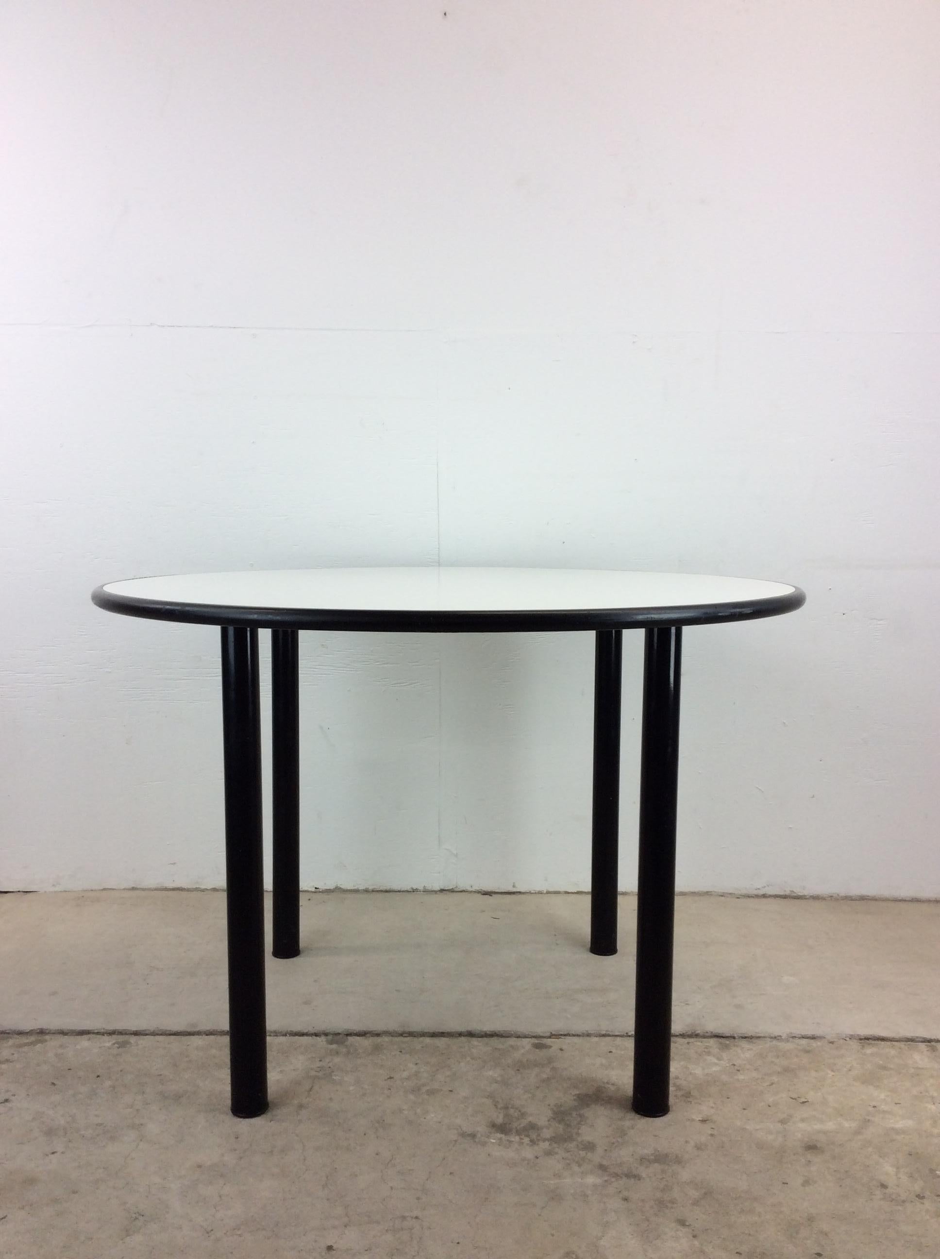 This vintage IKEA dining table features round design with white lacquer top and rounded black metal legs.

Complimentary set of 4 cafe style IKEA chairs available separately. 

Dimensions: 43w 43d 29h 27.5ch

Condition: Original white vinyl top has