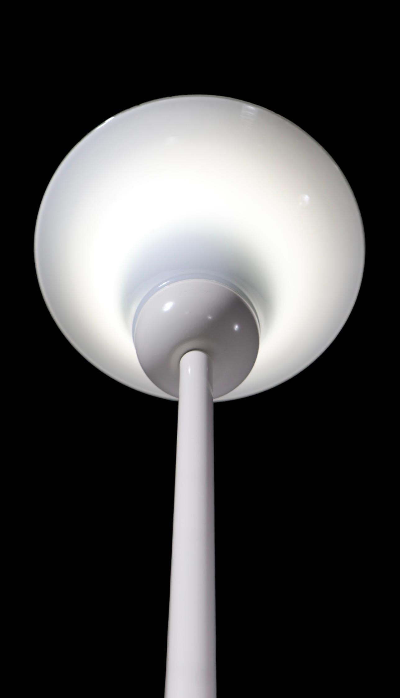 Sophisticated modern  minimalist design, white on white floor lamp, made  by Ikea, in the style of Max Bill, circa 1970/80's. The lamp features an elegant elongated vertical center post, with white glass cup form shade top, and foot operated in line
