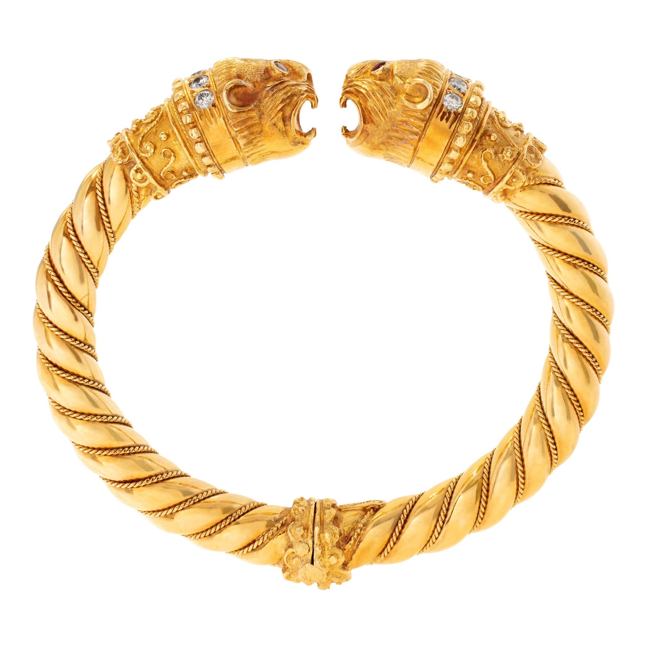 Vintage Greek designer Ilias Lalaouinis for Zolotas, original double Chimera heads design bangle bracelet in 18K yellow gold. Chimera heads have approx 1.00 carat round brilliant cut diamonds collar and pair of brilliant cut rubies eyes each. Bangle