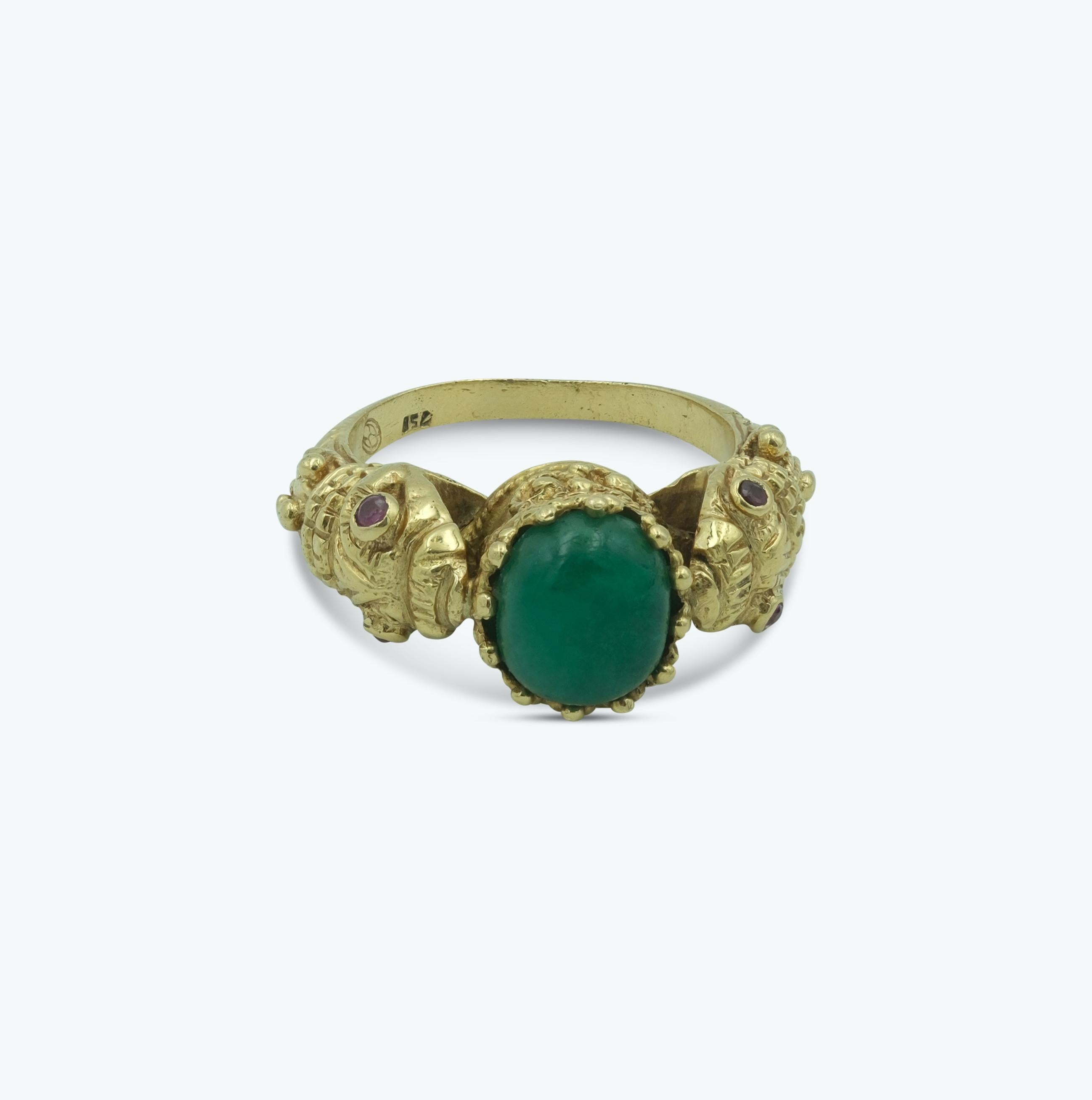 This unique vintage Ilias Lalaounis 18k yellow gold emerald & ruby double snake figural ring is a stunning example of intricate design and craftsmanship. Crafted in 18 karat yellow gold, the ring features a double snake motif, with each serpent's