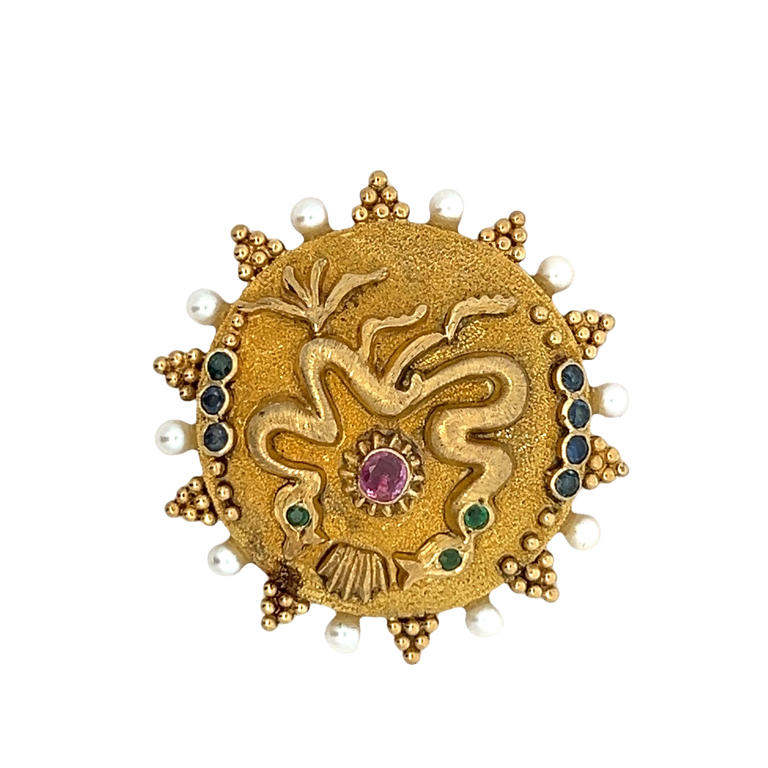 An exceptional 18K yellow gold creation by renowned Greek jeweler Ilias Lalaounis, this vintage piece embodies timeless elegance and Hellenic artistry. Weighing 21.9 grams, it features a radiant combination of round emeralds, rubies, sapphires, and