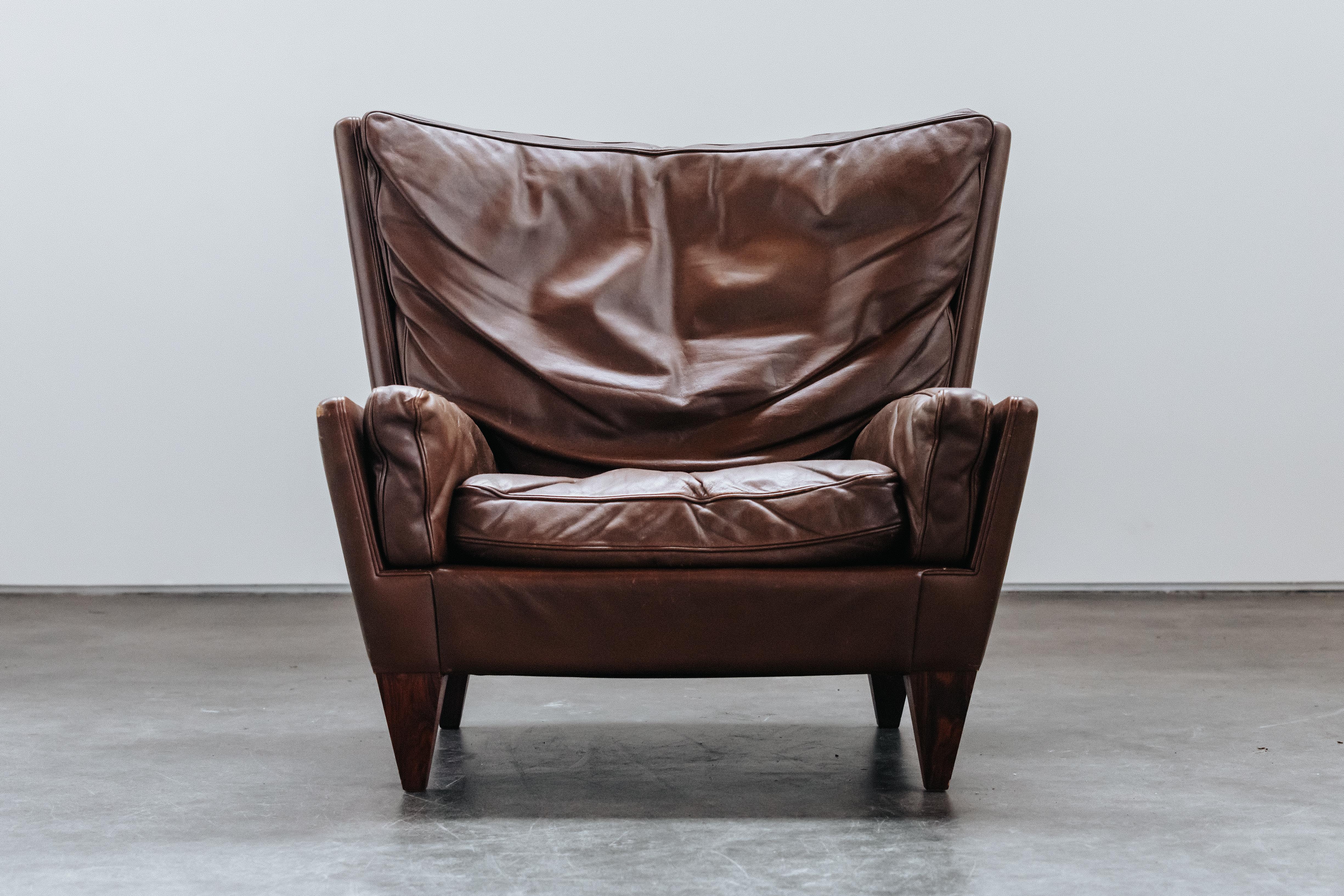 Vintage Illum Wikkelso V11 Chair From Denmark, 1960s.  Original brown leather upholstery with light wear and patina.  