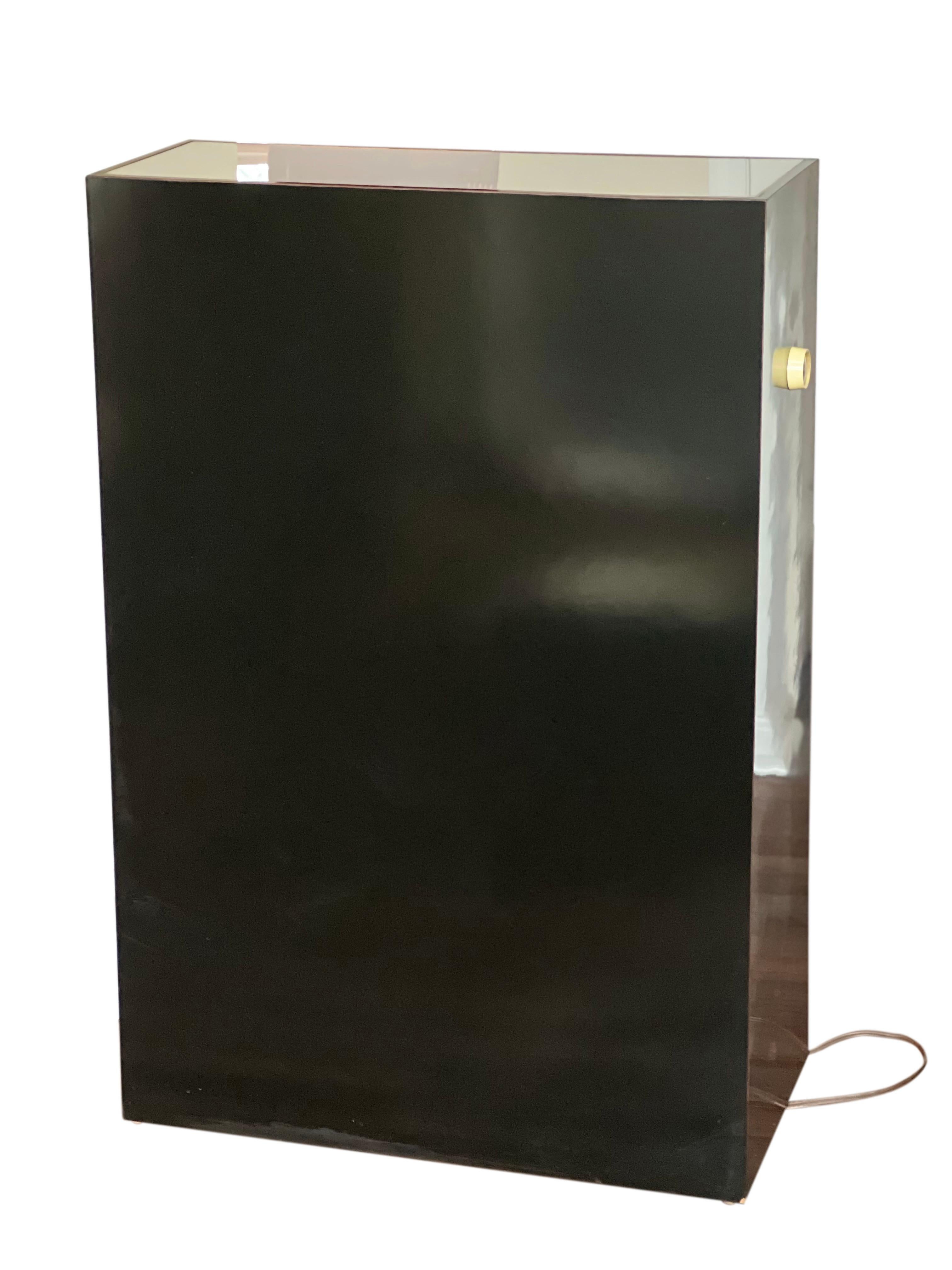 Fabulous all original vintage illuminated glossy black pedestal with an opaque white acrylic inset top.

The pedestal creates a luminous glow perfect to display your favorite sculpture or objets d’art with adjustable lighting. Crafted of wood