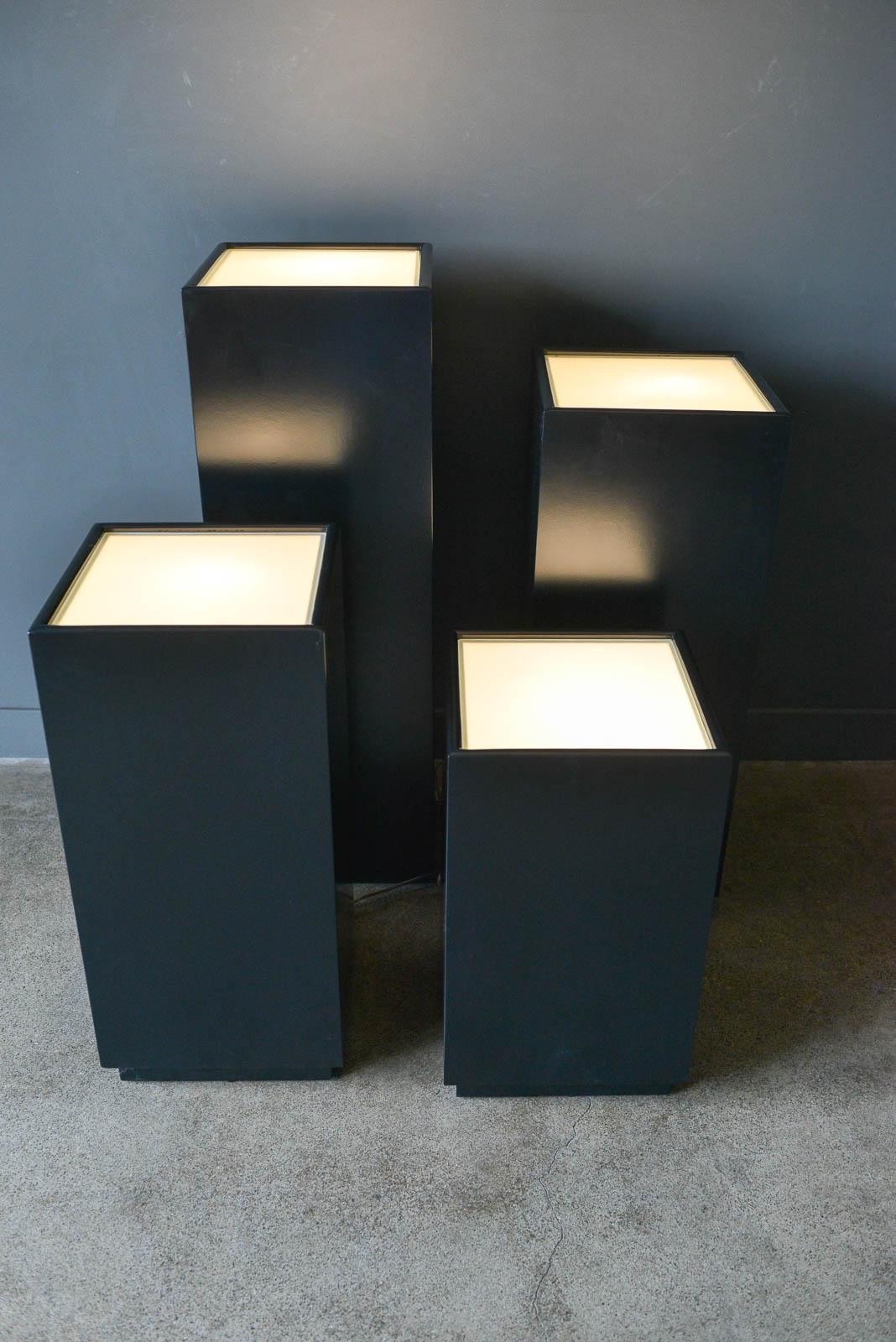 Vintage Illuminated Display Pedestals by Albright and Zimmerman, ca. 1984. Original frosted glass and round dimmer switches. Perfect for displaying art and sculpture. Professionally restored in black with white interior to reflect more light onto