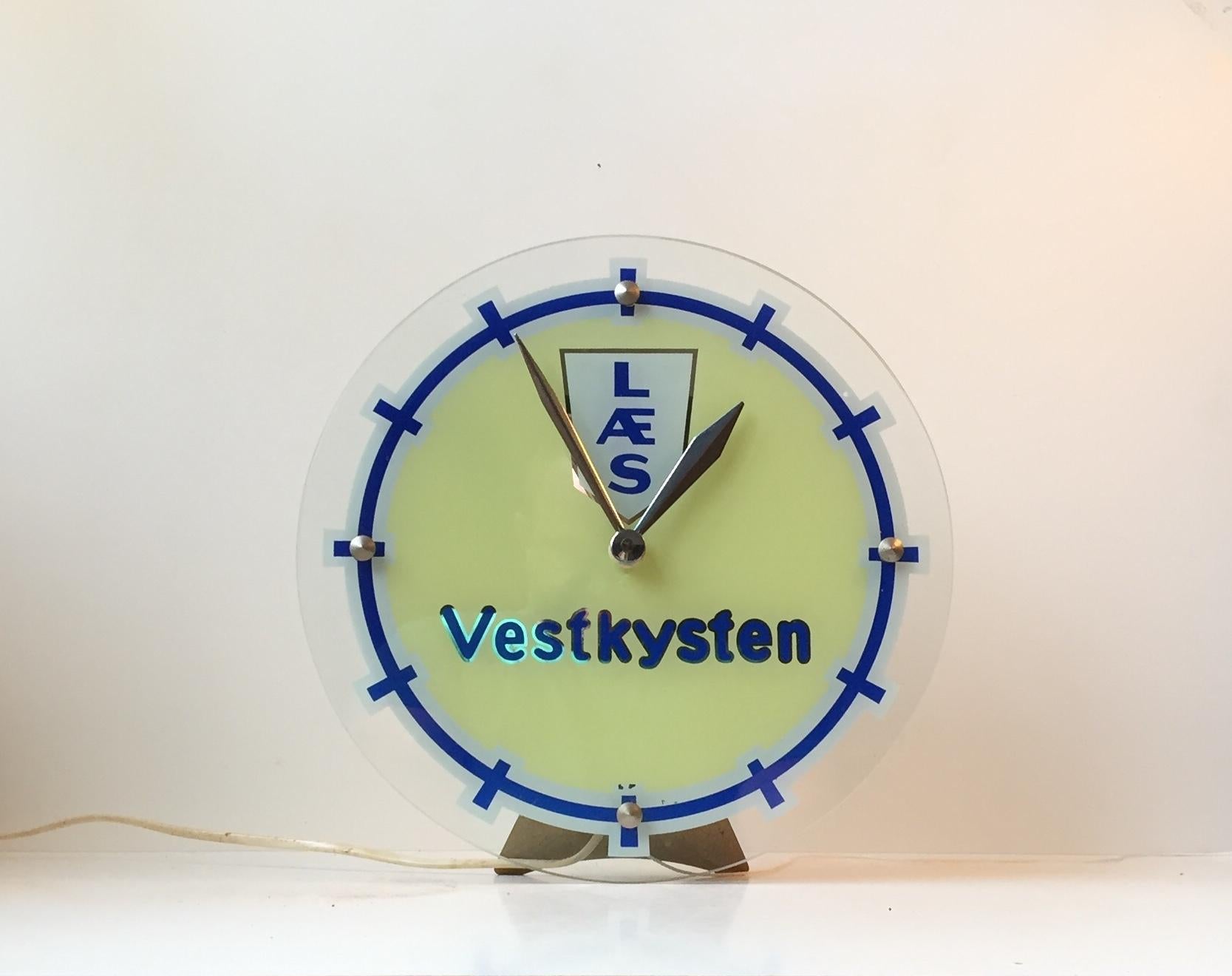 - Illuminated electrical wall or table clock manufactured by Halux in Flensburg, Germany
- It was for the Danish newspaper Jyske Vestkysten
- Only 8 examples were made for the newspaper's administrations and offices
- The blue and yellow clock
