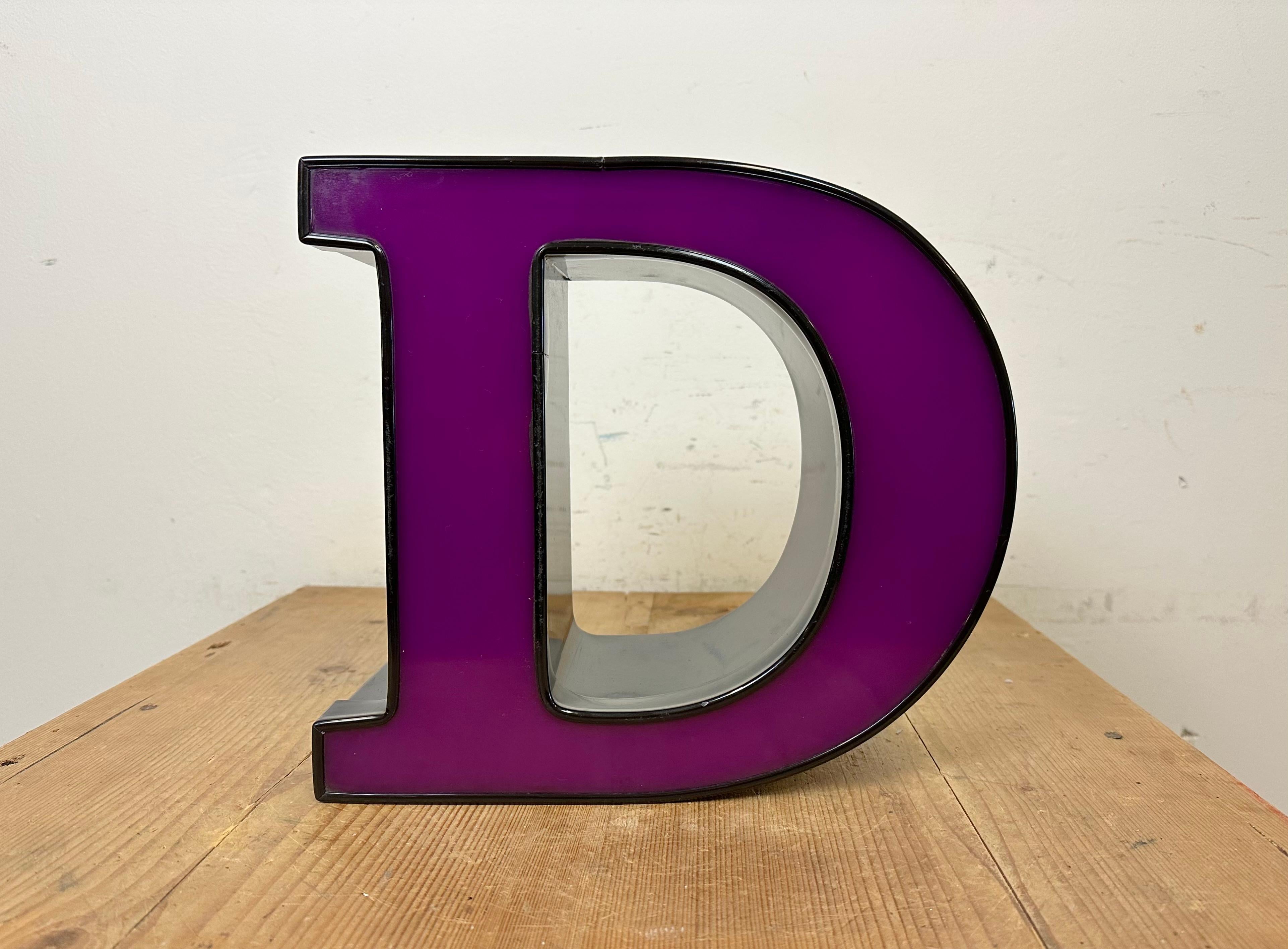 Questa lettera D illuminata vintage Industrial è stata realizzata in Italia negli anni '80 e proviene da un vecchio banner pubblicitario. Presenta un corpo in metallo nero e un coperchio in plexiglas viola. È dotato di una striscia LED. La lettera
