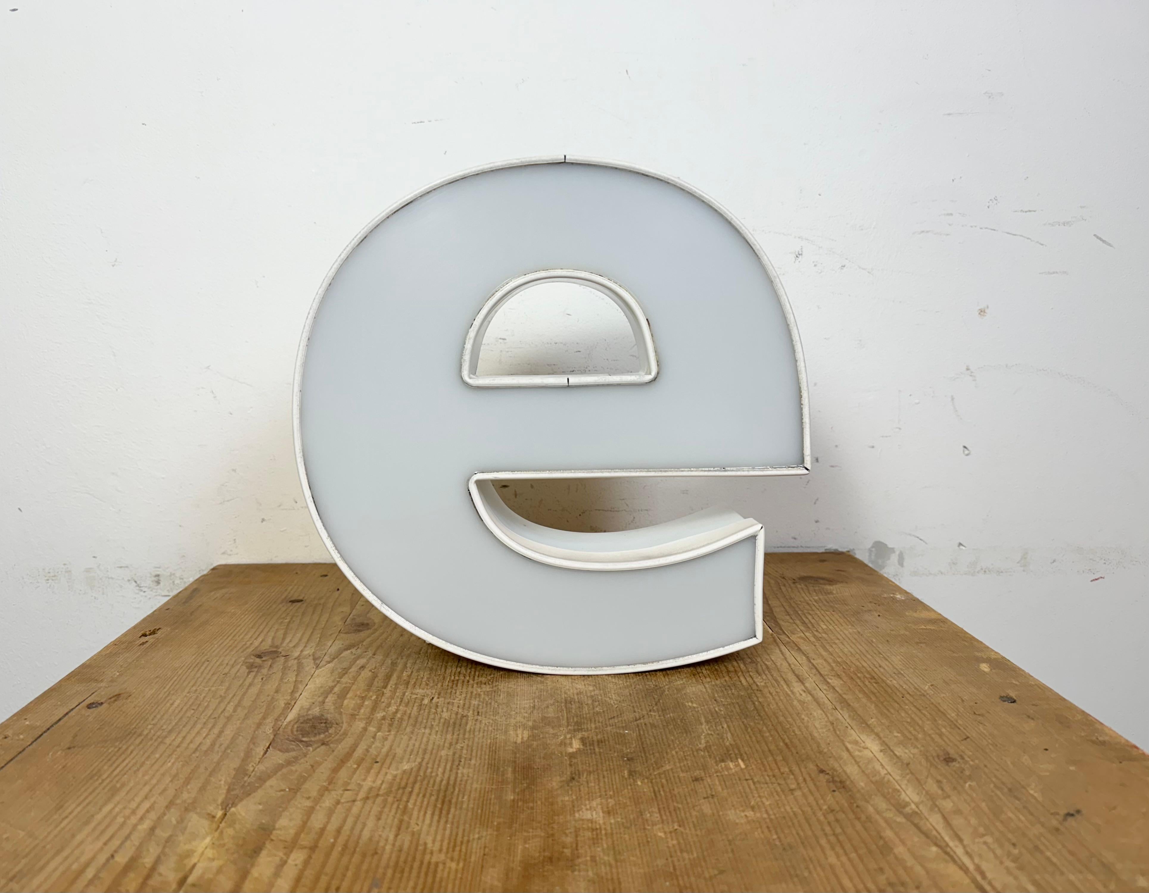 This vintage industrial illuminated letter E was made in Italy during the 1980s and comes from an old advertising banner. It features a vhite metal body and a white plexiglass cover. It is equipped with a LED strip. The letter can be used as a table