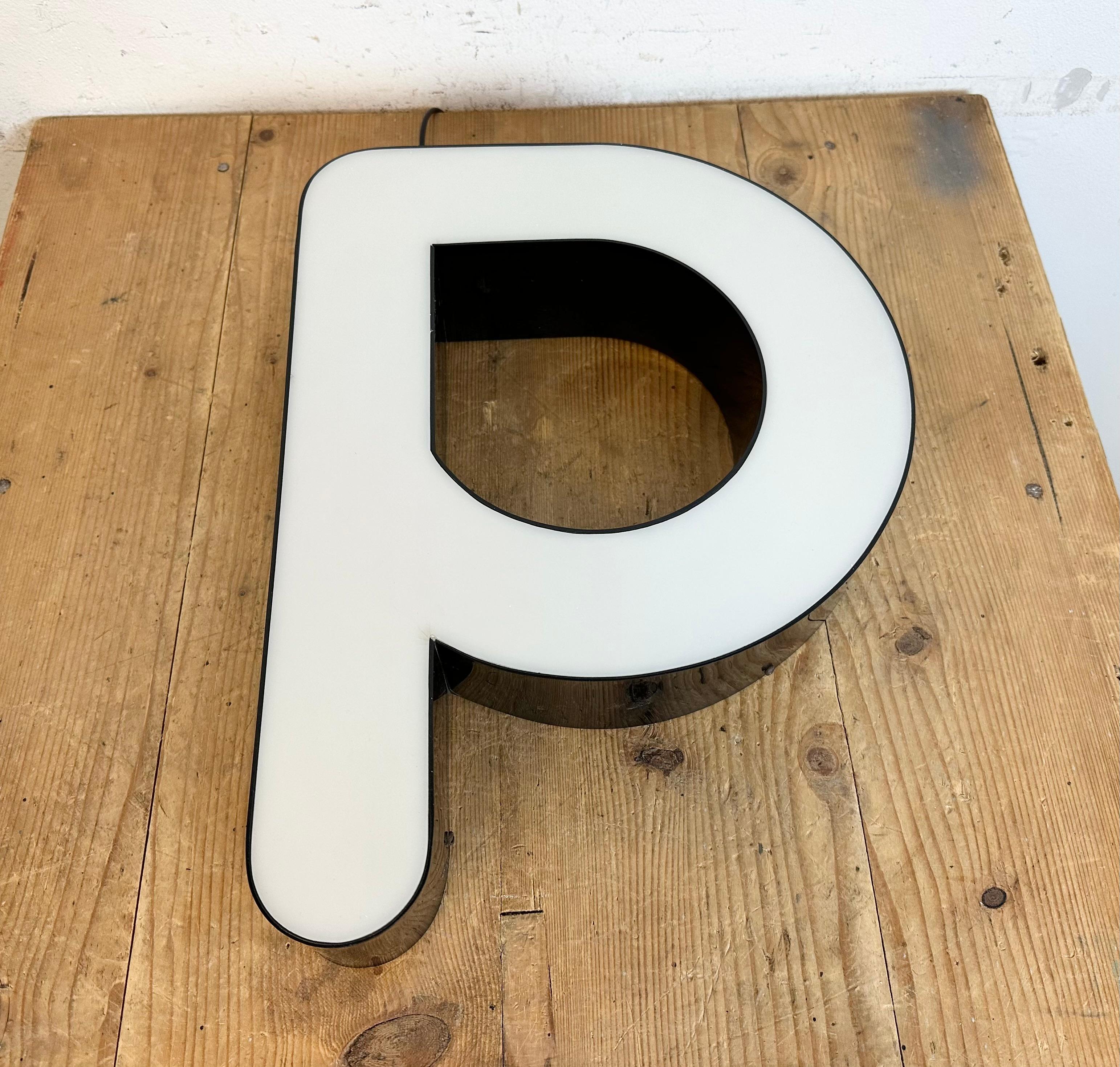 This vintage industrial illuminated facade letter P was made in Italy during the 1970s and comes from an old advertising banner. It features a black bakelite body and a white plexiglass cover. It is equipped with a LED strip..The weight of the