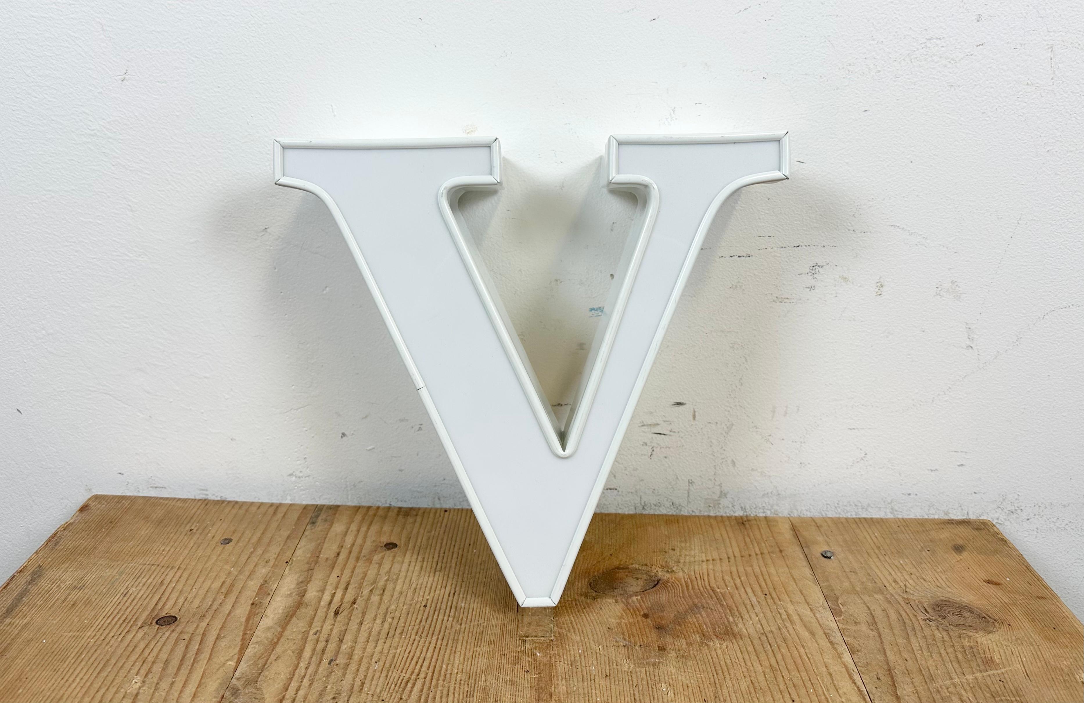 This vintage industrial illuminated letter V was made in Italy during the 1980s and comes from an old advertising banner. It features a vhite metal body and a white plexiglass cover. It is equipped with a LED strip. The letter can be used as a table