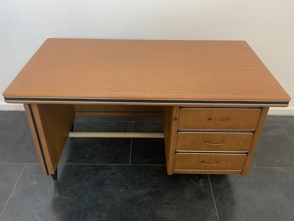 Leatherette desk with wood finish. Gilt metal hardware, profiles, handles and tips. Insignificant signs of time and wear.
Packaging with bubble wrap and cardboard boxes is included. If the wooden packaging is needed (fumigated crates or boxes) for