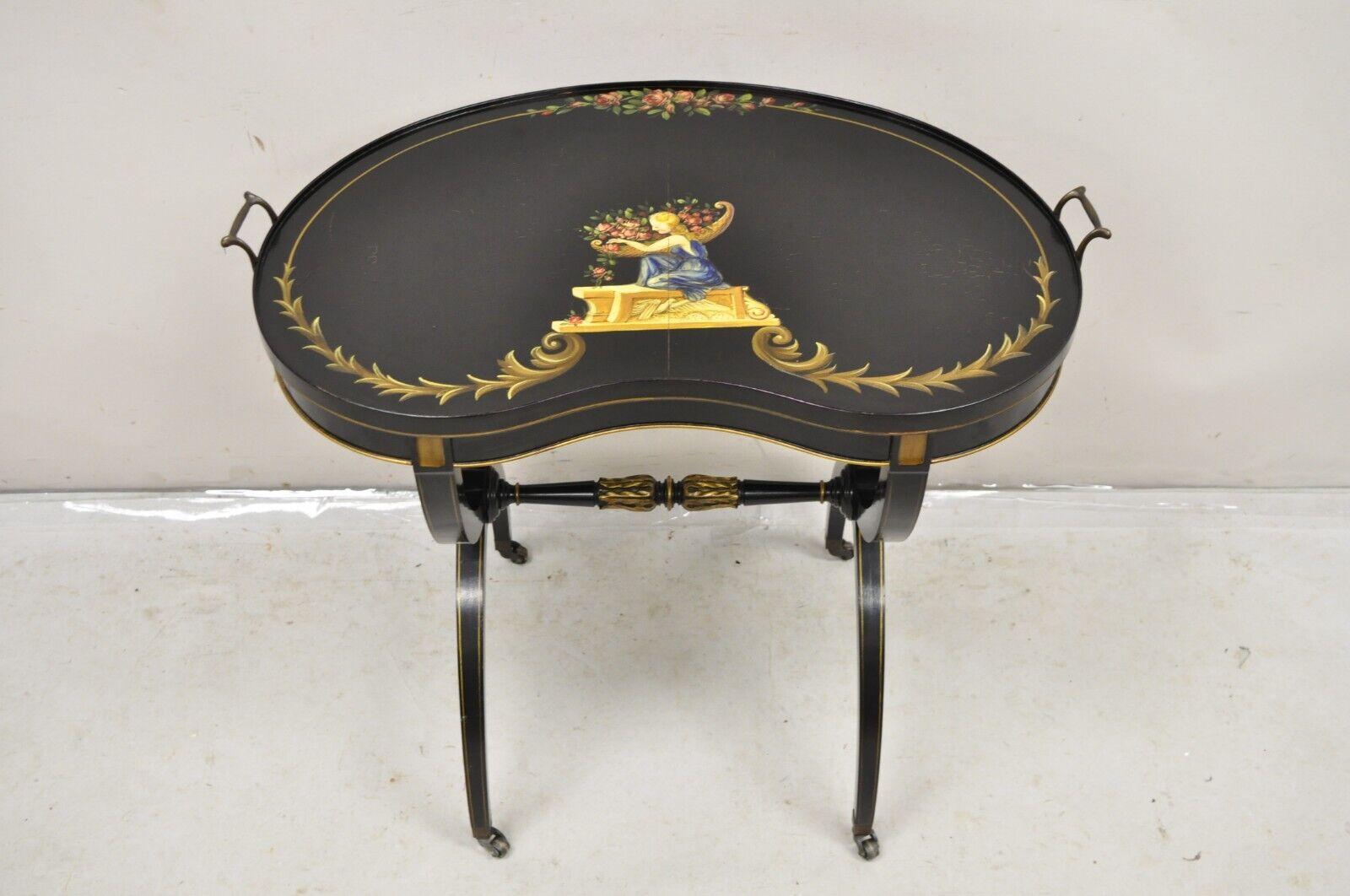Vintage Imperial Furniture Regency Style Black Hand Painted Curule Kidney Side Table. Item features hand painted top of woman in blue dress with flowers and other gold scrollwork, brass rolling casters, kidney shaped top, brass handles, original