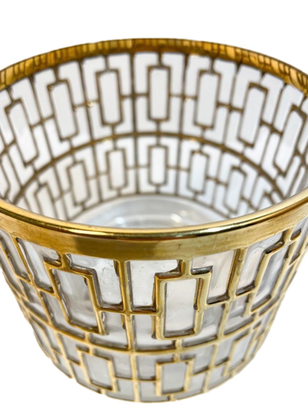 Mid-Century Modern ice bowl and 6 rocks glasses made by Imperial Glass Co. in the Shoji Pattern. Each piece is molded with a raised pattern inspired by Japanese Shoji screens, the raised areas are then gilded in 22k gold.