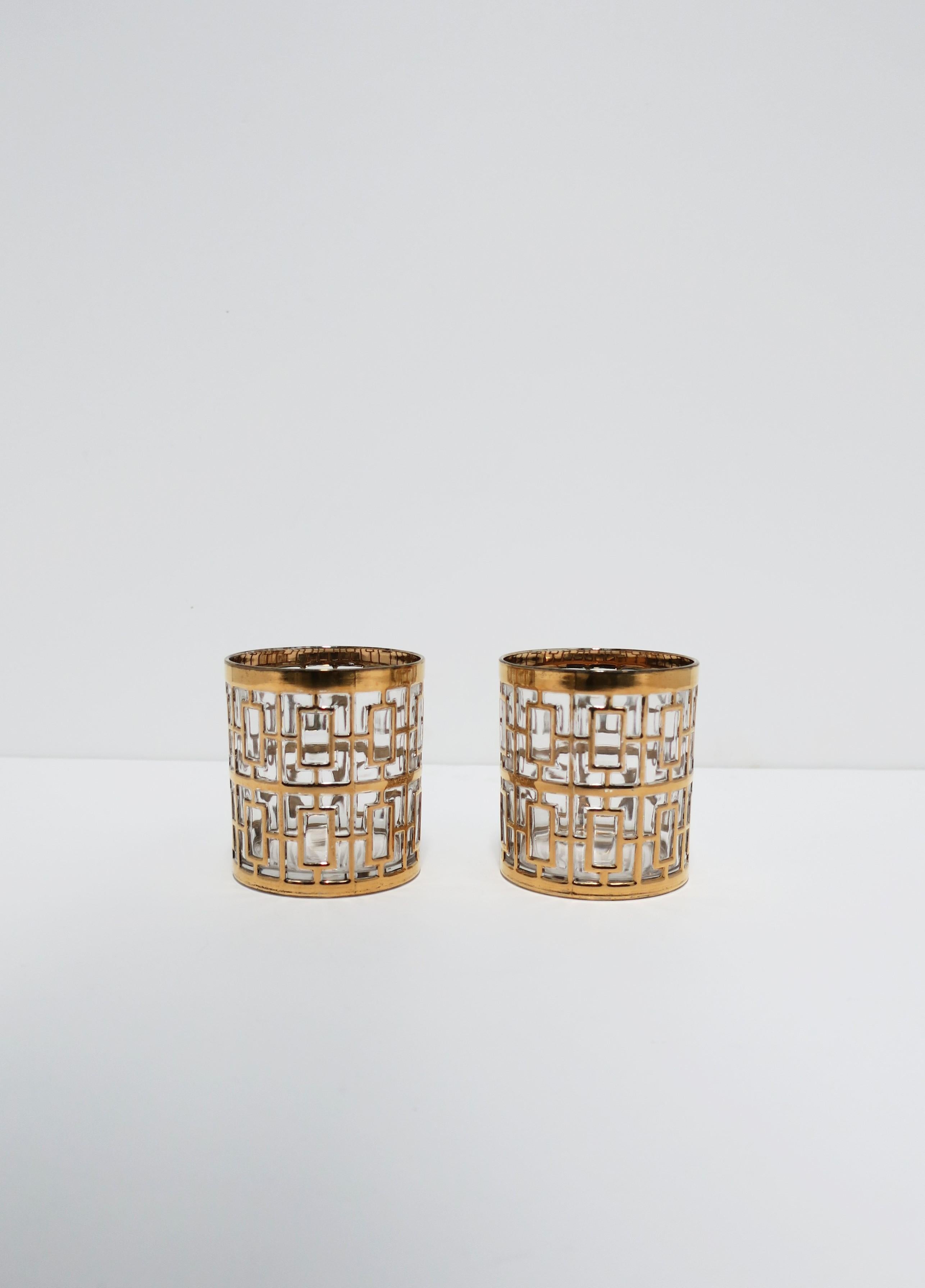 A beautiful vintage set of two (2) cocktail rock's glasses in the Hollywood Regency style by Imperial Glass Co., circa 1960s, USA. Glasses have a 22-karat gold-plate overlay on clear glass in the 'Shoji' screen pattern, which was signature to the