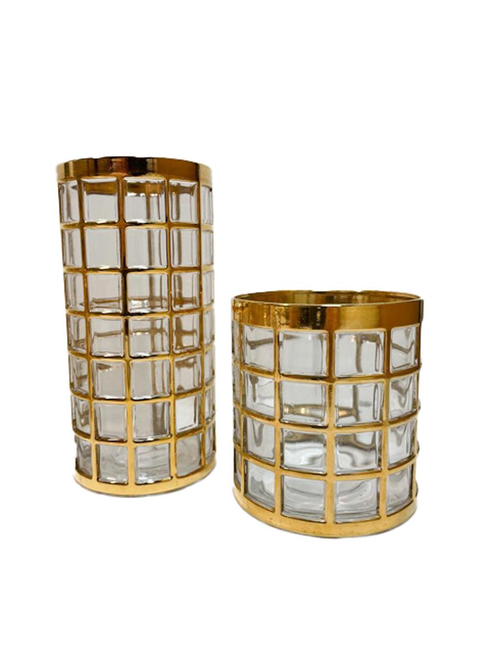 Set of 16 mid-century modern bar glasses made by Imperial Glass Co. in the Toril de Oro pattern. Each glass is molded with a raised grid of squares with, all of the raised surfaces covered in 22 karat gold. The set consists of 6 highball and 6 rocks