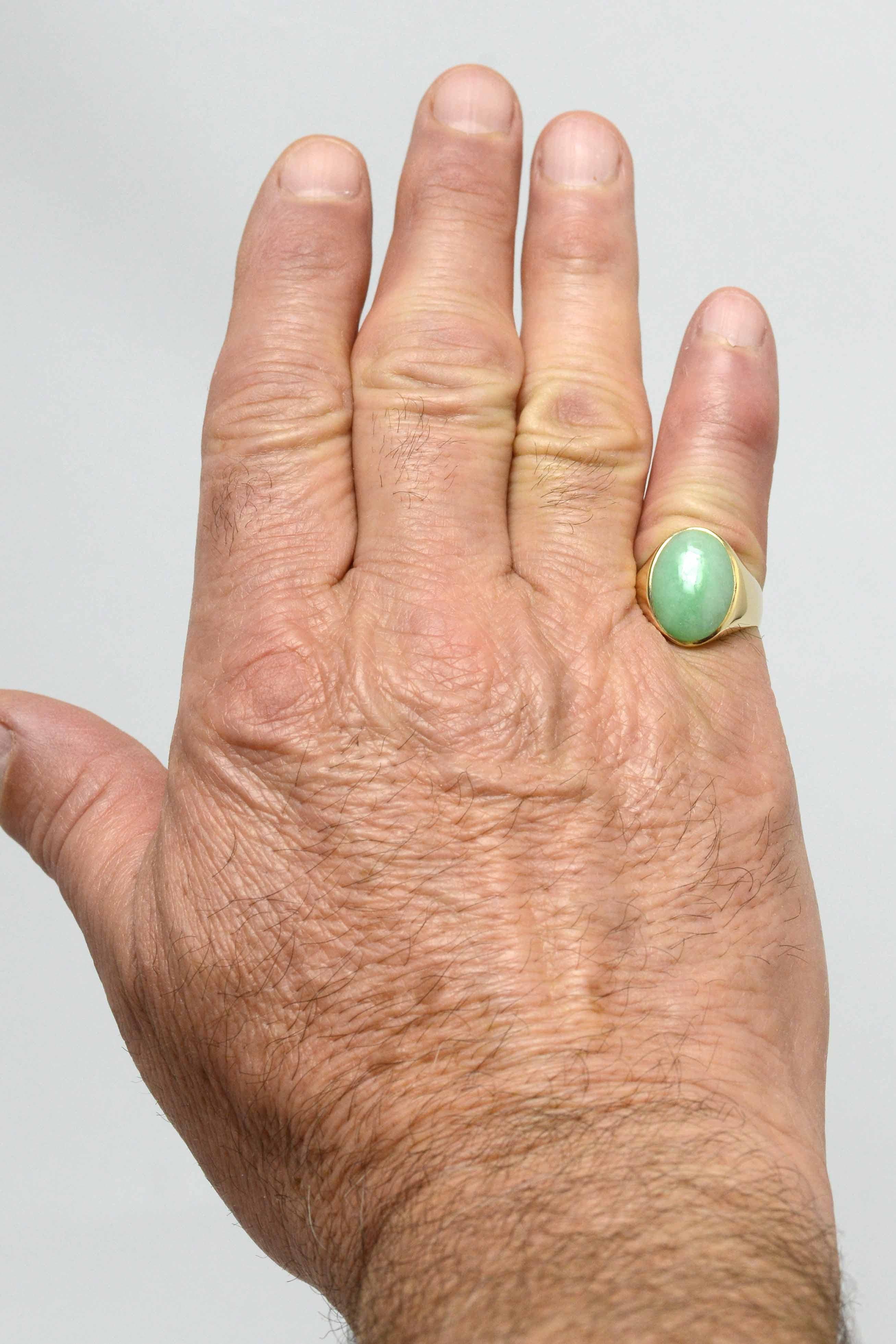 This vintage imperial jade men's ring is a timeless classic. Centering on a vivid green jadeite cabochon with a lovely, lustrous watery feel. No evidence of treatment or dye is present in this shimmering, natural Burmese jade. A unisex design, can