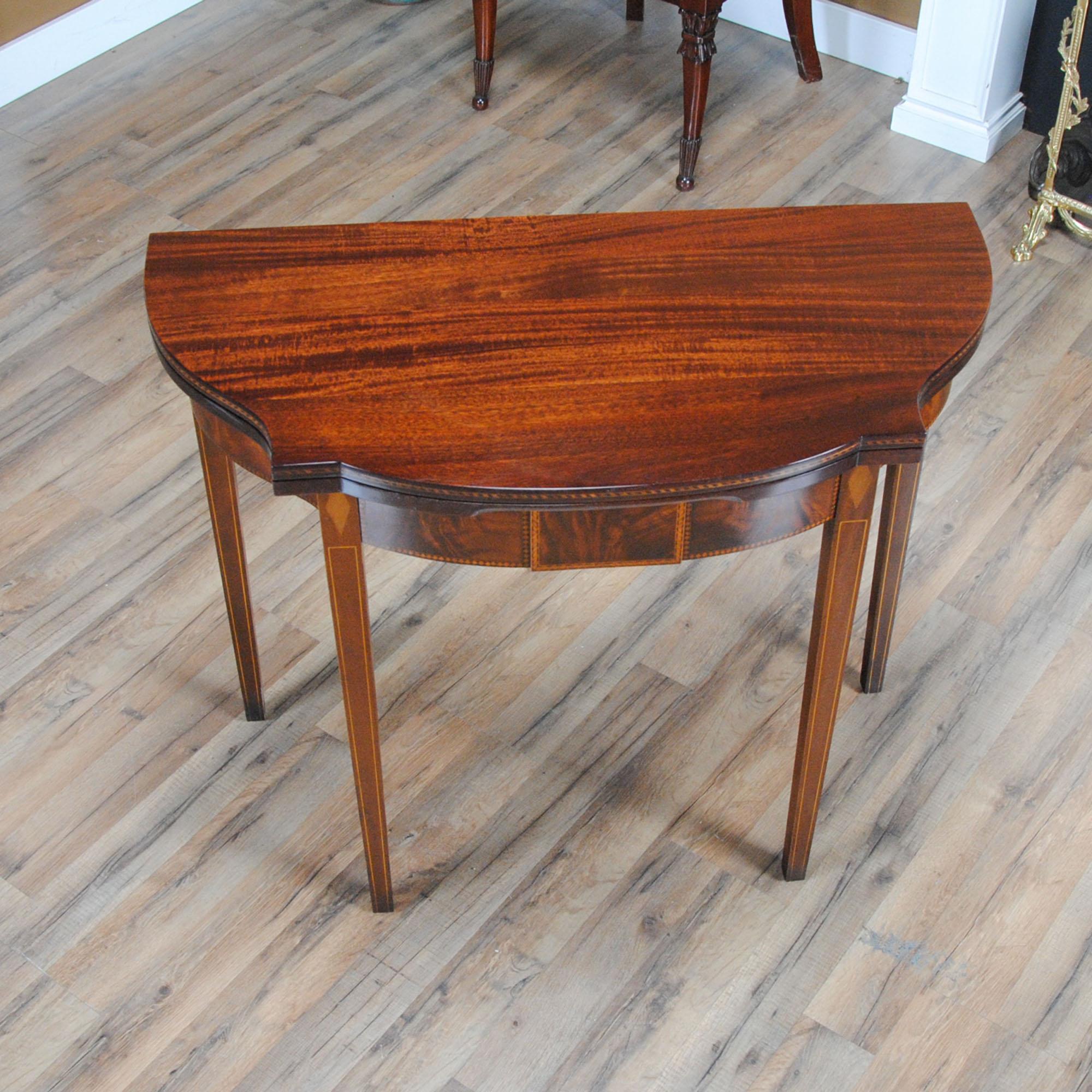 A Vintage Imperial Mahogany Game Table featuring a beautifully shaped top with fine quality mahogany grain and a double banded herringbone inlaid edge. Designed after an antique original this Vintage Imperial Mahogany Game Table was produced in the