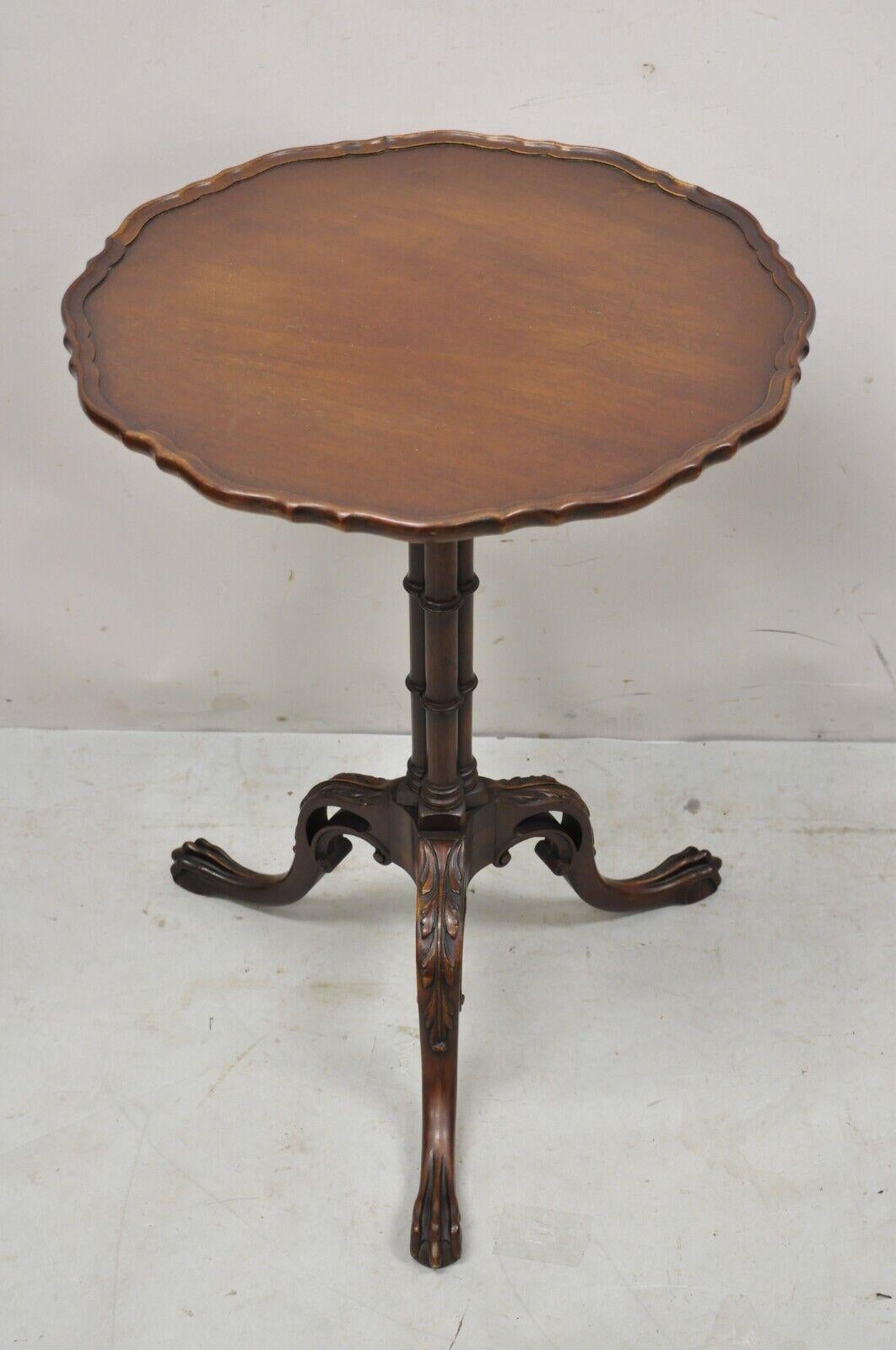 Vintage Imperial mahogany Georgian Style pedestal base tea table side table. Item features carved paw feet, pedestal base, beautiful wood grain, nicely carved details, original label, very nice vintage item, great style and form. Circa Early 20th
