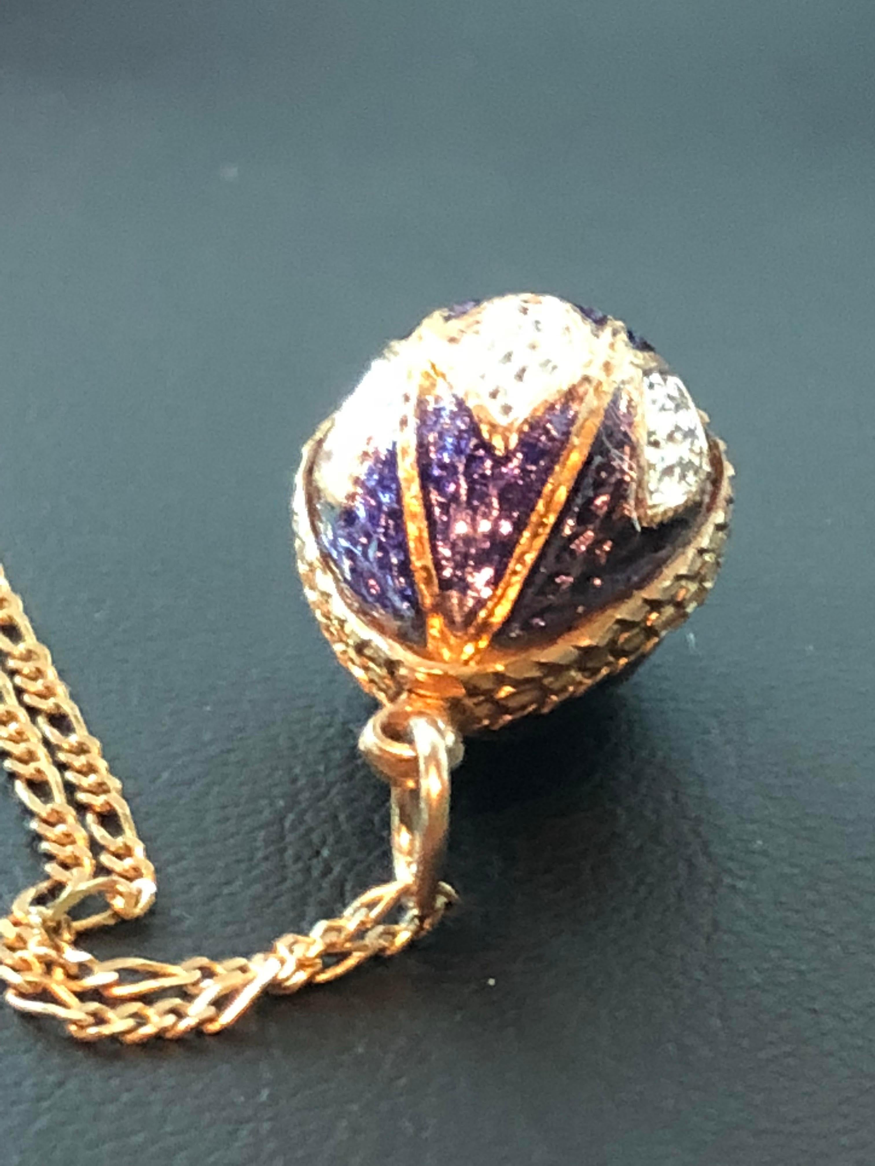 Antique Russian Sterling and 18k gold egg charm pendent guilloche purple, white enamel - red gem on the bottom.
There are two small spots with age on purple area. 

There are no markings or hallmarks

The gold has been tested and it tests to be 18k