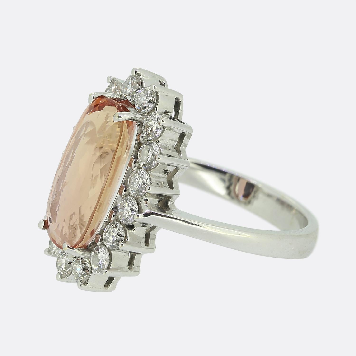 Here we have an impressive imperial topaz and diamond cluster ring. The ring is crafted in 18ct white gold and plays host to a central pinky orange topaz that is surrounded by a border of seventeen round brilliant cut diamonds.

Condition: Used