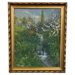 Cuadro impresionista vintage de un paisaje primaveral con un arroyo, en un marco con tonos dorados.