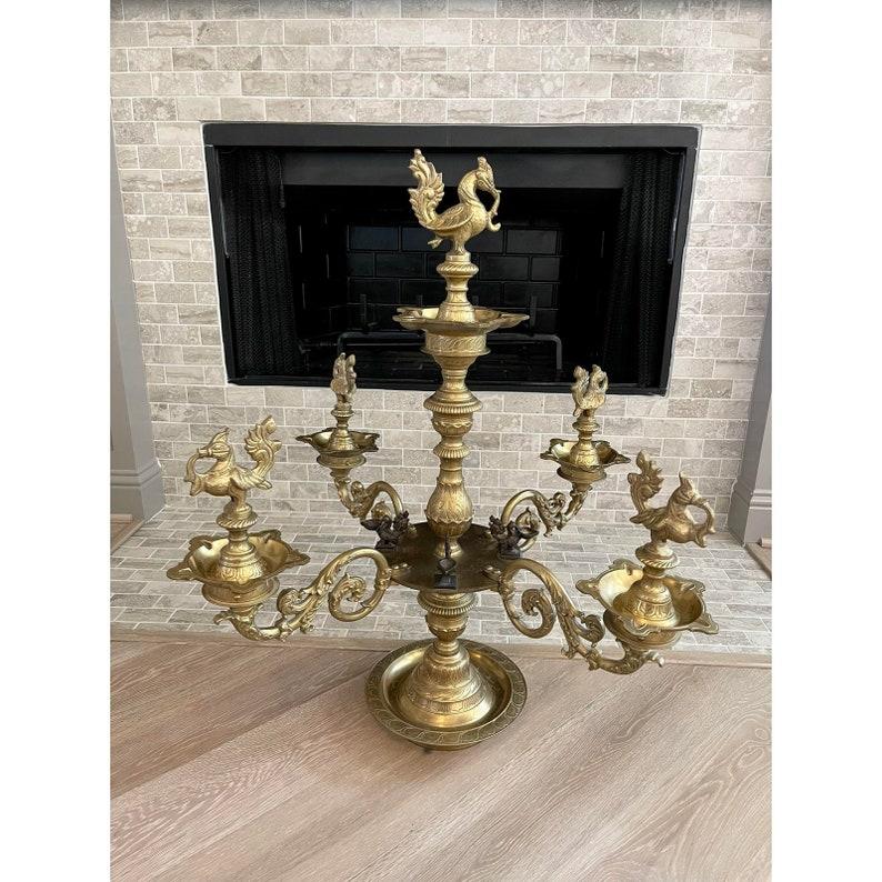 A most impressive size South Indian temple ornamental Nachiarkoil lamp (Annam lamp), consistenting of a series of diya oil lamps, four scrolled arms extend from a central turned column pedestal. Large scale, heavy, very high quality brass, adorned