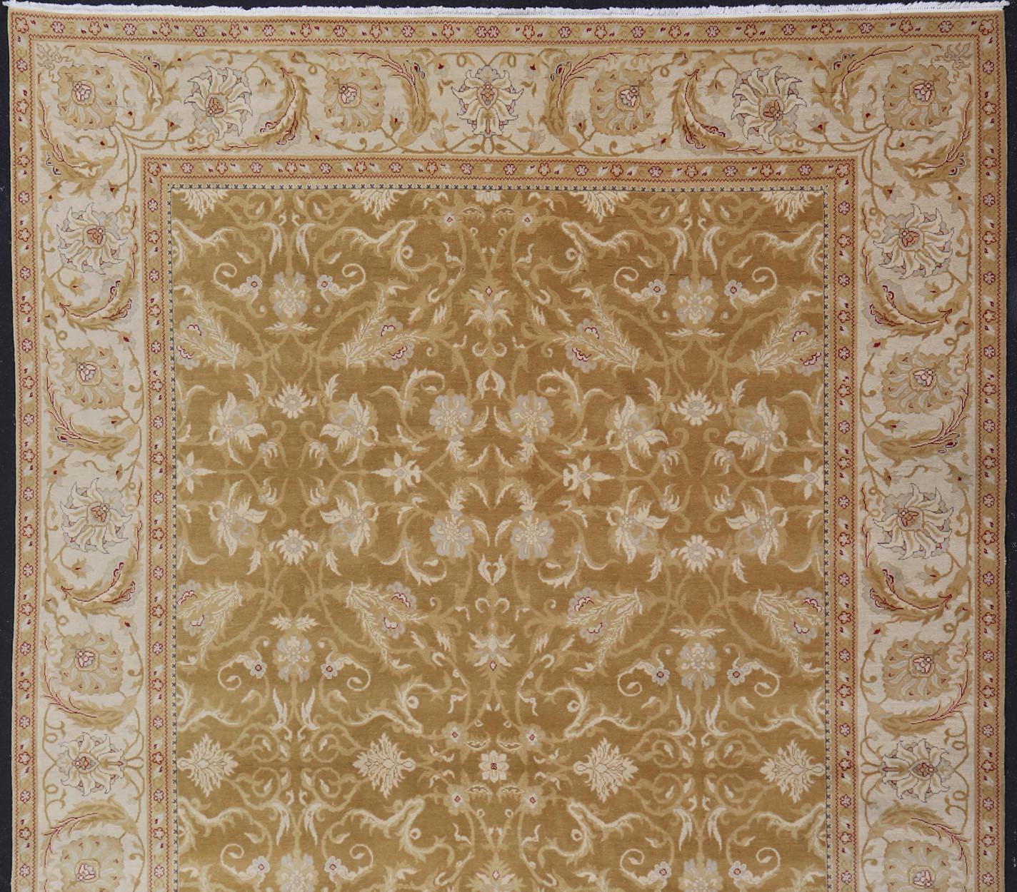 This beautiful hand-knotted woolen Amritsar rug features a floral design enclosed within a complementary all-over design. The Rug consists of a greenish-tan background, with accents in Ivory, Cream, Red and Gray-blue. Keivan Woven Arts /